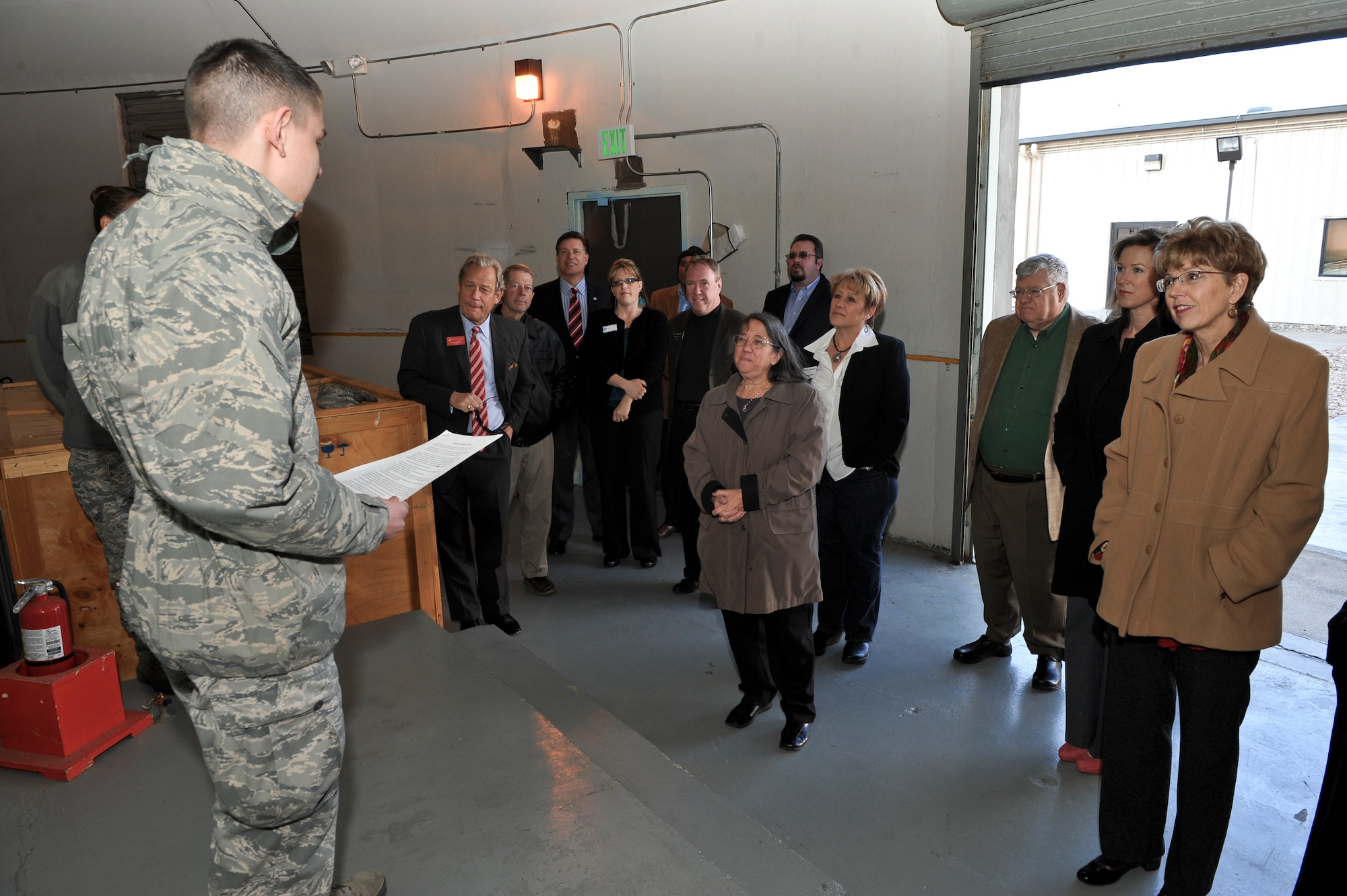 Airman 1st Class Nikolas Sanford, 460th Space Communications Squadron radio frequency transmission specialist, explains to participants of Mayors’ Day how information is received from satellites Feb. 1, 2013, at Buckley Air Force Base. Mayors’ Day allowed local Colorado mayors to visit Buckley, learn its mission and create more transparency between Buckley and the community. (U.S. Air Force photo by Airman 1st Class Phillip Houk/Released)