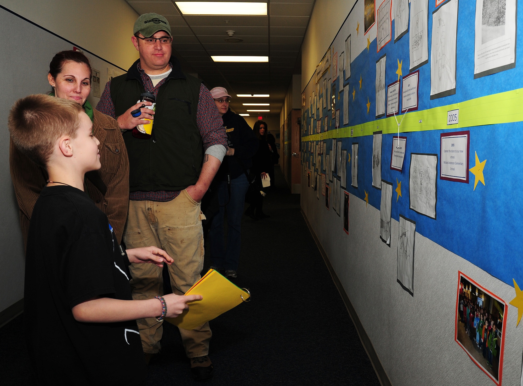 Jase Winner shows parents a timeline display depicting the life of Lt. Col. Michael Anderson at Fairchild Air Force Base, Wash., Jan. 31, 2013. The school held an assembly marking the tenth anniversary of the Columbia disaster. (U.S. Air Force photo by Airman 1st Class Janelle Patiño)