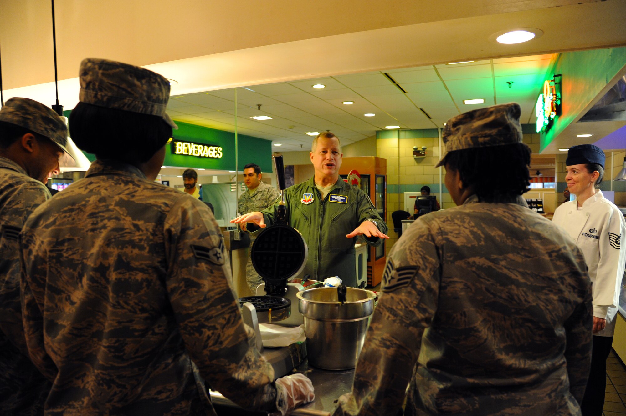 U.S. Air Force Maj. Gen. Lawrence Wells, Commander, 9th Air Force, Air Combat Command greets Service members in the dining facility at Langley Air Force Base, Va., Jan. 30, 2013. Wells spoke about his experiences in the Air Force as an officer with fellow Airmen. (U.S. Air Force photo by Airman First Class Victoria Taylor/ Released)