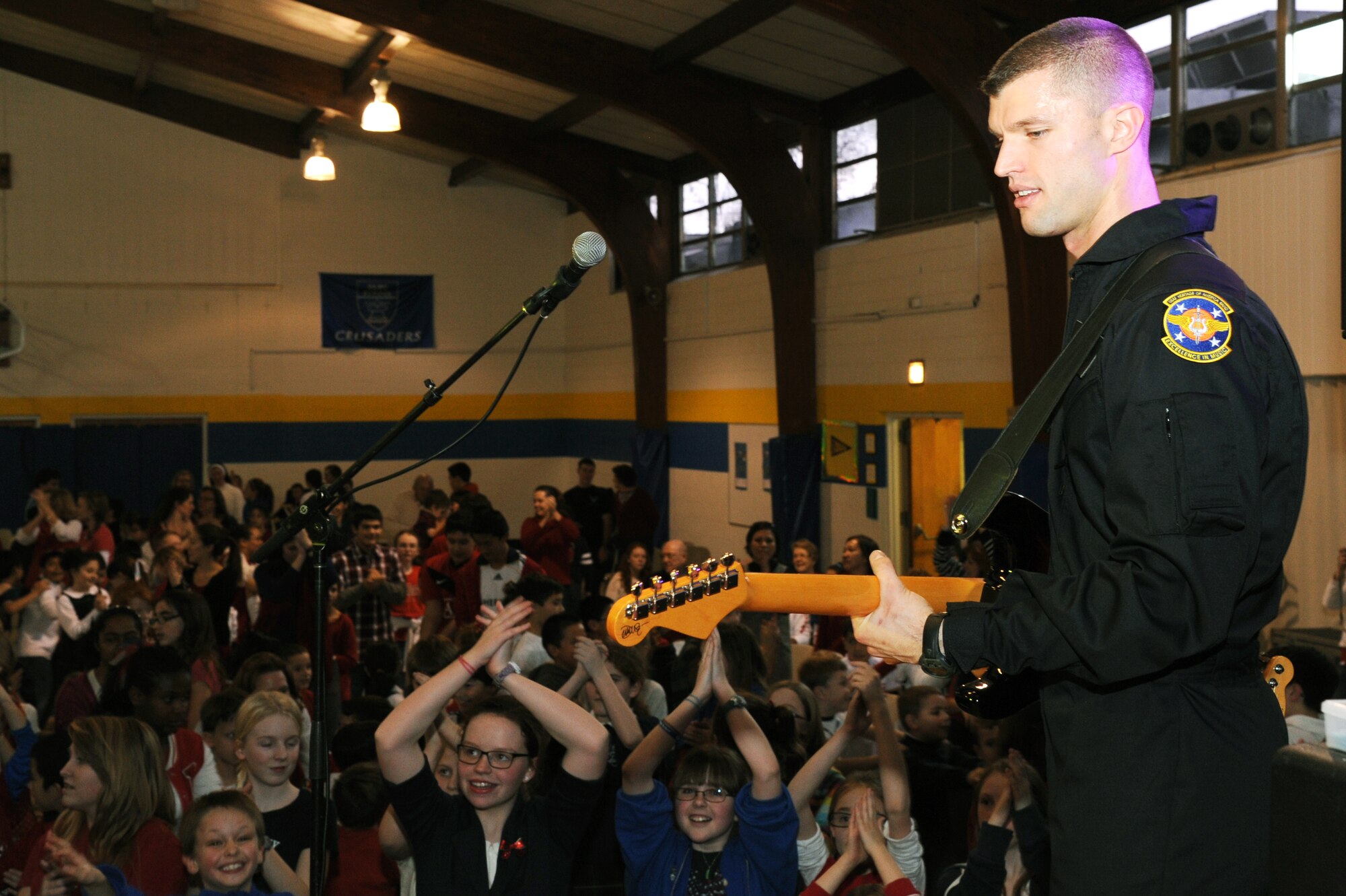 U.S. Air Force Staff Sgt Dustin Trimble, Guitarist and Vocalist of the Band “The Blue Aces”, plays for the students of Our Lady of Mount Carmel School at Newport News, Va., Jan 28, 2013. In celebration of National Catholic Education Week, OLMC provided a spirit week for the children. (U.S. Air Force photo by Airman First Class Victoria Taylor/ Released)
