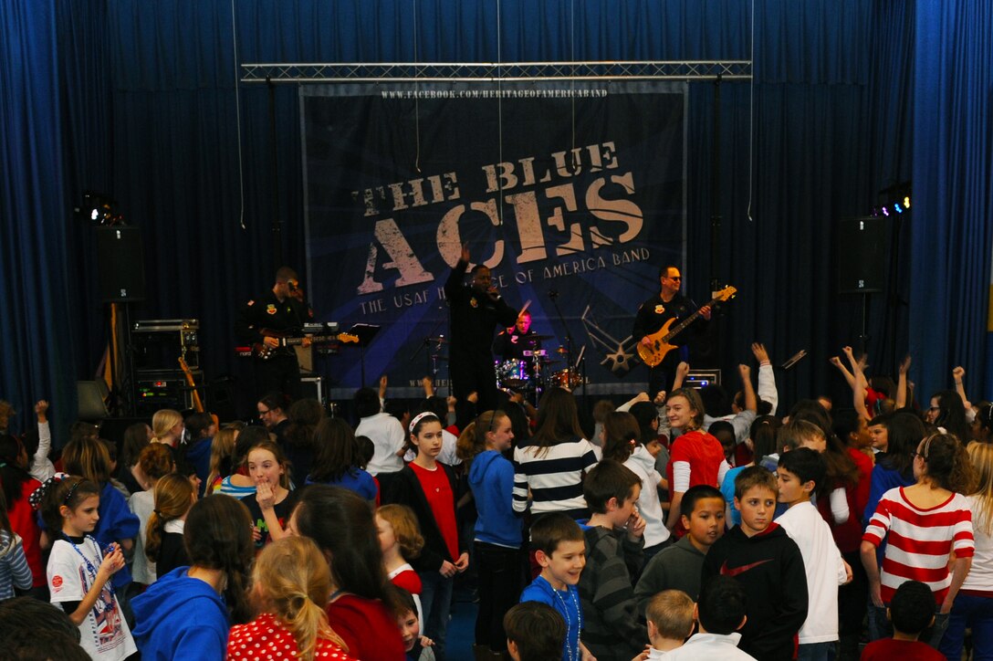 U.S. Air Force Heritage band “The Blue Aces” plays for childern of the Our Lady of Mount Carmel School at Newport News, Va., Jan. 28, 2013. Childern of the Catholic school were encouraged to dress in patriotic colors in celebration of National Catholic Education Week. (U.S. Air Force photo by Airman First Class Victoria Taylor/ Released)