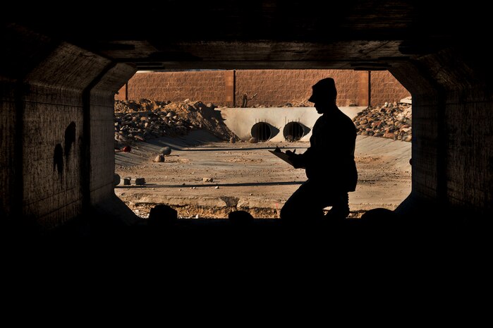 An Airman from the 99th Civil Engineer Squadron surveys the concrete density of a new flood wash gully Feb. 4, 2013, at Nellis Air Force Base, Nev. The new gully was installed during the construction of a new roundabout which will be finished June 1. (U.S. Air Force by Photo Senior Airman Daniel Hughes)