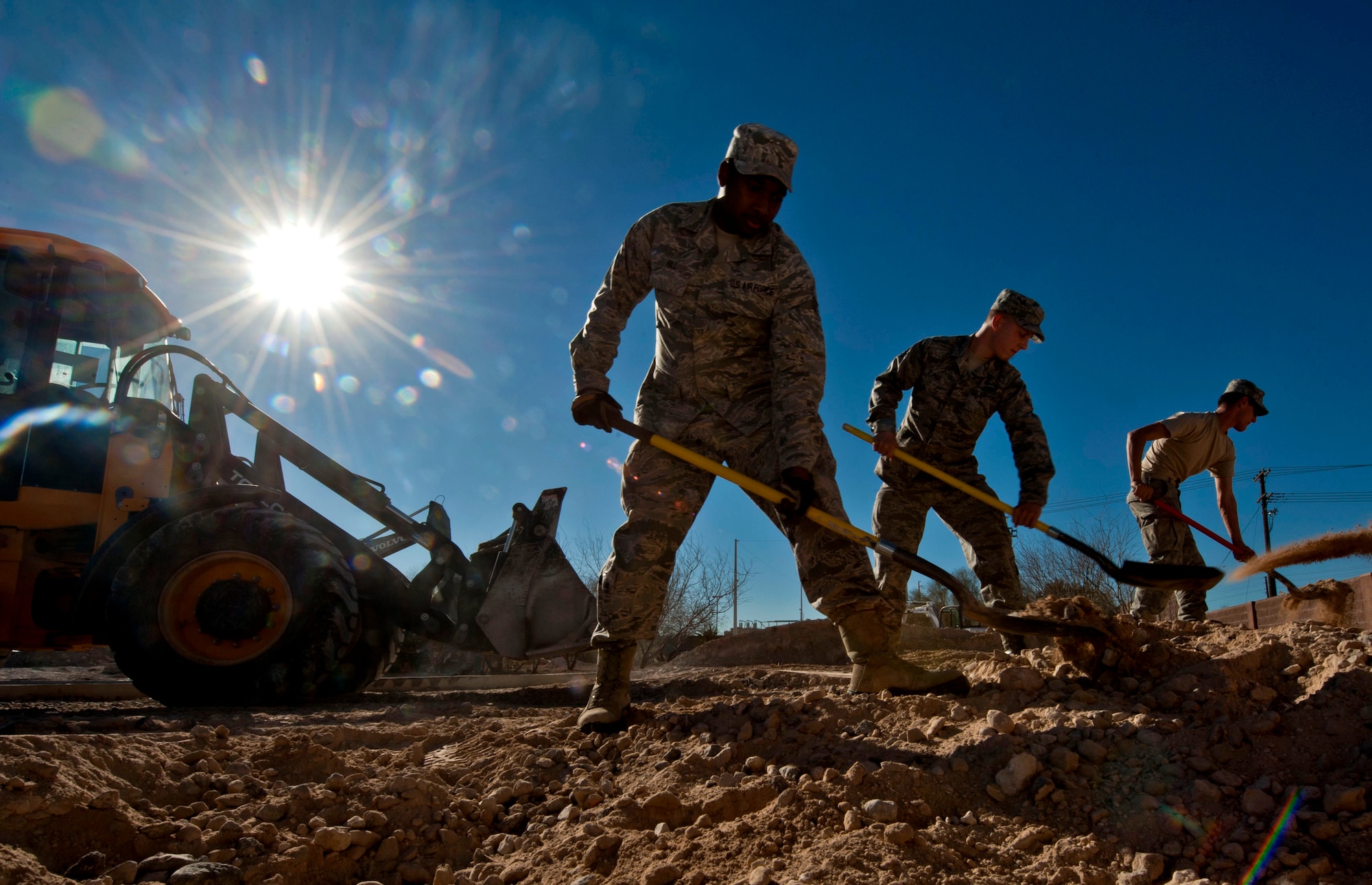 Airmen from the 99th Civil Engineer Squadron cover piping for a pop up barrier conduit Feb. 4, 2013, at Nellis Air Force Base, Nev. The new pop up barriers will be installed to prevent gate runners from entering the base. (U.S. Air Force by Photo Senior Airman Daniel Hughes)