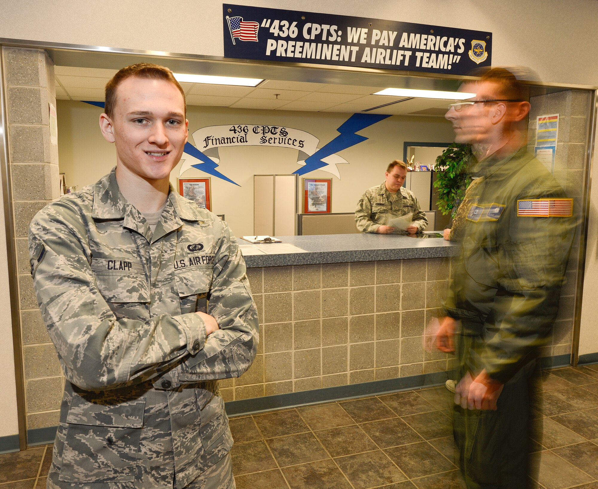 Airman Colton Clapp (foreground) is one of the dedicated 436th Comptroller Squadron airman who contributed to the unit winning the 2012 Air Mobility Command Financial Services Office of the Year award. Clapp is shown in front of the units busy customer service counter on Feb. 5, 2013 at Dover Air Force Base, Del. Clapp is from Daytona Beach, Fla. USAF photo/Greg L. Davis