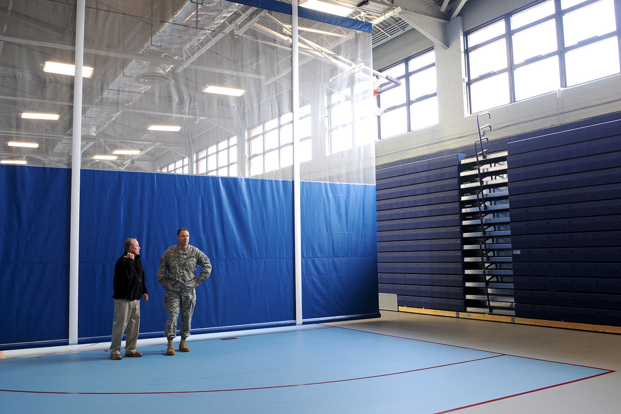 William Vonohlen, 733rd Force Support Division Sustainment Branch chief, (left), gives U.S. Army Col. Thomas R. Wetherington, 733rd Mission Support Group commander, a tour of a separated classroom area of Anderson Field House at Fort Eustis, Va., Feb. 4, 2013. The fitness center features various new amenities, including an expanded women’s locker room and three sectioned-off areas of the basketball court for one-on-one classroom utilization. (U.S. Air Force photo by Staff Sgt. Ashley Hawkins/Released)