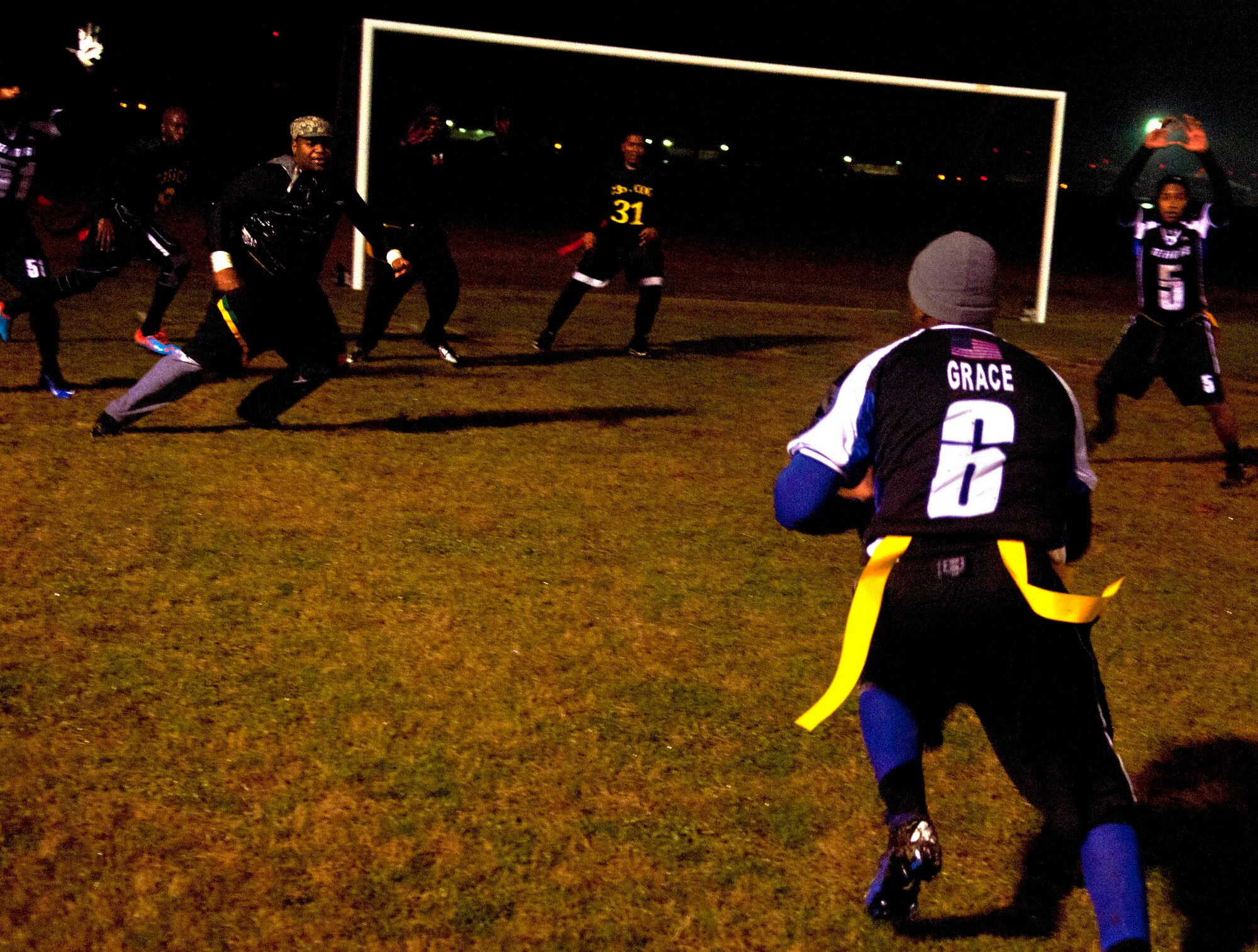 Senior Airman Antonio Grace, 633rd Security Forces Squadron head football coach, surveys the field during a conversion after a touchdown against the 735th Supply Chain Operations Group at Langley Air Force Base Jan. 14. Grace believes hard conditioning prior to the season led his team to success. (U.S. Air Force photo by Airman 1st Class Austin Harvill/Released) 