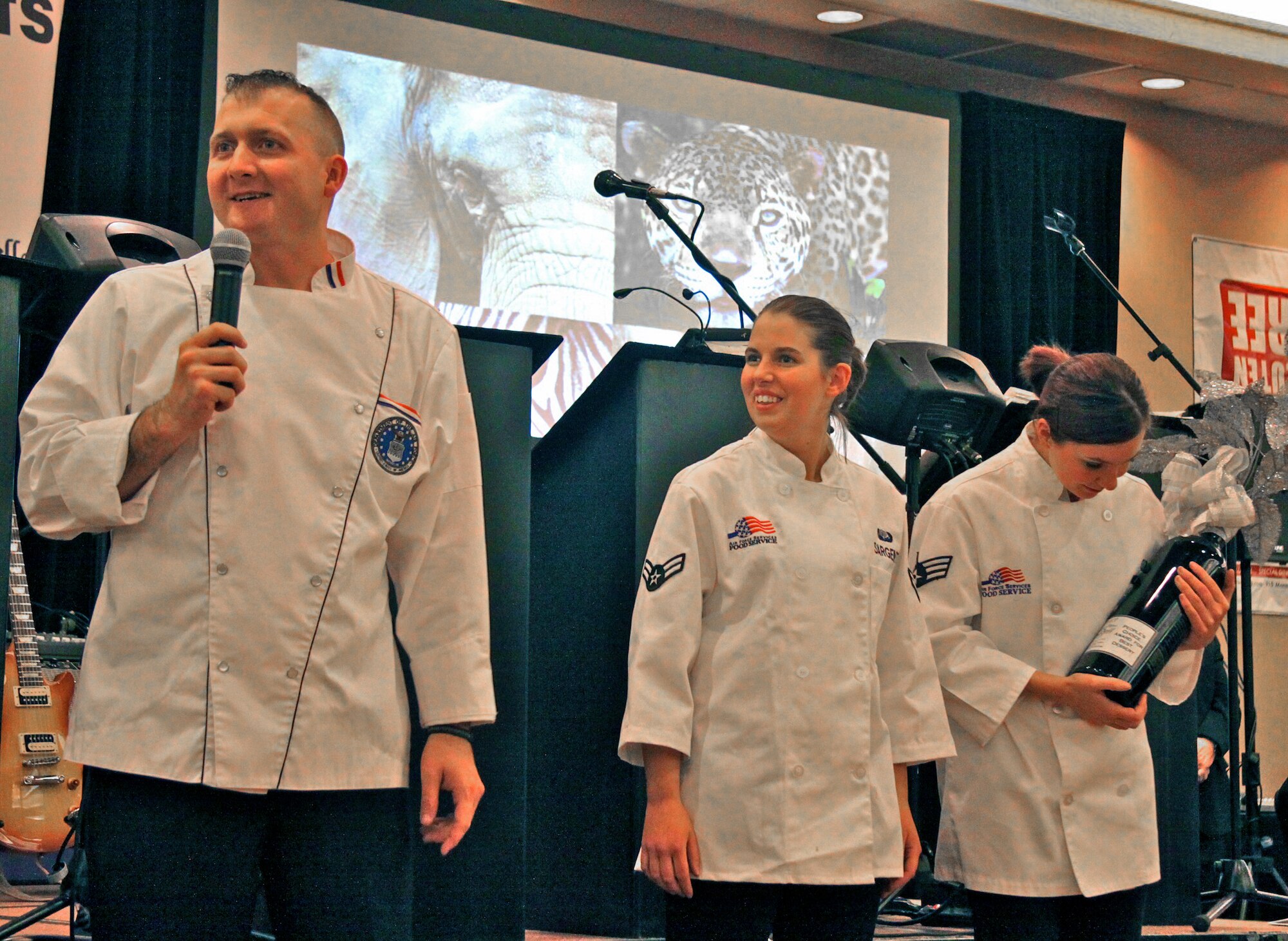 COLORADO SPRINGS, Colo. -- Staff Sgt. Joshua Pallardy, Airman 1st Class Bridget Sargent and Senior Airman Candace Phillipo, from the Aragon Dining Facility, accept the People’s Choice Best Dessert award at the Glass Slipper Ball Jan. 26 at the DoubleTree hotel. The team entered a New York cheesecake tower with strawberry coulis, and a graham cracker slipper topped with vanilla icing and a blue glaze. The team competed against chefs from restaurants across the local area. (Photo courtesy Matthew Schniper, Colorado Springs Independent)