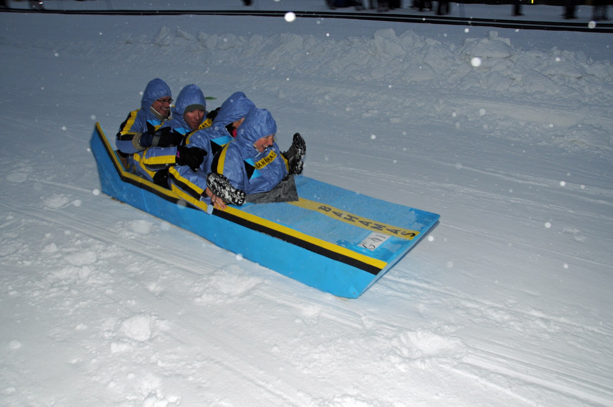 KEYSTONE, Colo. -- The “Bahamian Bobsled team” from Peterson Air Force Base slides down the slope in the SnoFest cardboard derby competition Jan. 26. The bobsledders were winners in the closest to the target competition and included Maj. DJ Cobb, Space and Missile Defense Command, and from NORAD/NORTHCOM Canadian Lt. Col. Rob Martin, Gretchen Bliss, and Lt. Col. Teaka Robba. (Photo courtesy/Herb Wetzel)