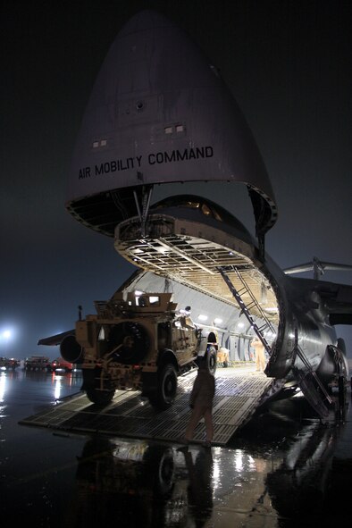 Ground crews secure mine-resistant, ambush-protected vehicles in the cabin of a U.S. Air Force C-5 Galaxy transport aircraft at Bagram Airfield, in Parwan province, Afghanistan, Feb. 2, 2013. Ground crews are able to load and off-load the C-5 simultaneously at the front and rear cargo openings, reducing cargo transfer times. (U.S. Army photo/1st Lt. Henry Chan)



