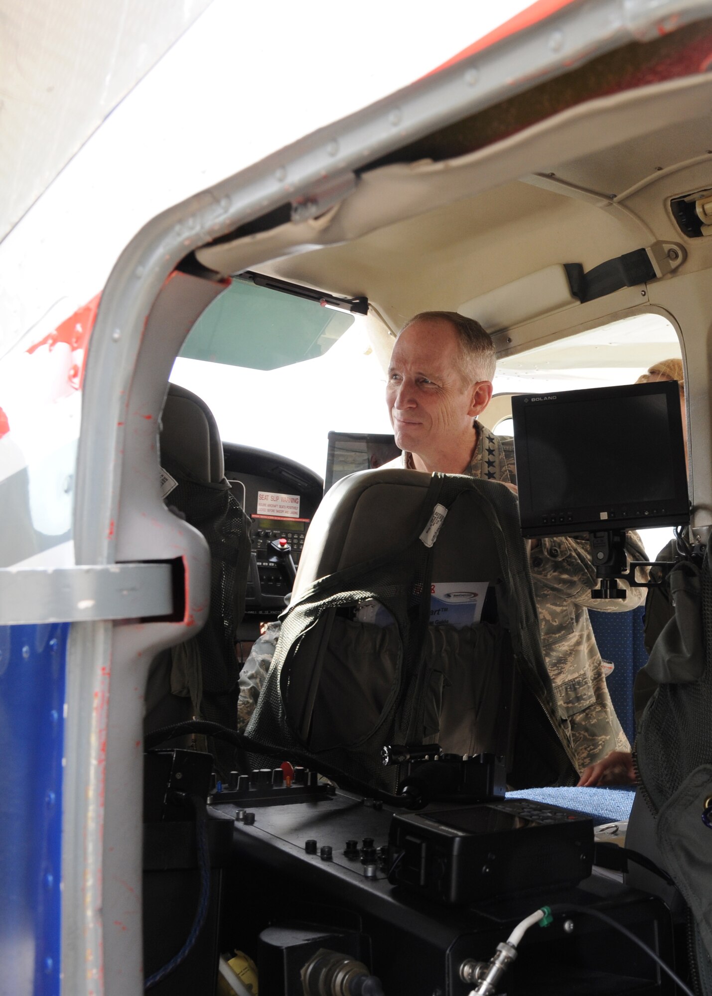 U.S. Air Force Gen. Mike Hostage, commander of Air Combat Command, tours the inside of a Surrogate Predator Cessna 182 at Fort Polk, La., Jan. 24. Civil Air Patrol members explained how the airborne platform of the Cessna 182 replicates predator operations using a manned platform. (U.S. Air Force photo/Airman 1st Class Joseph A. Pagán Jr./Released)