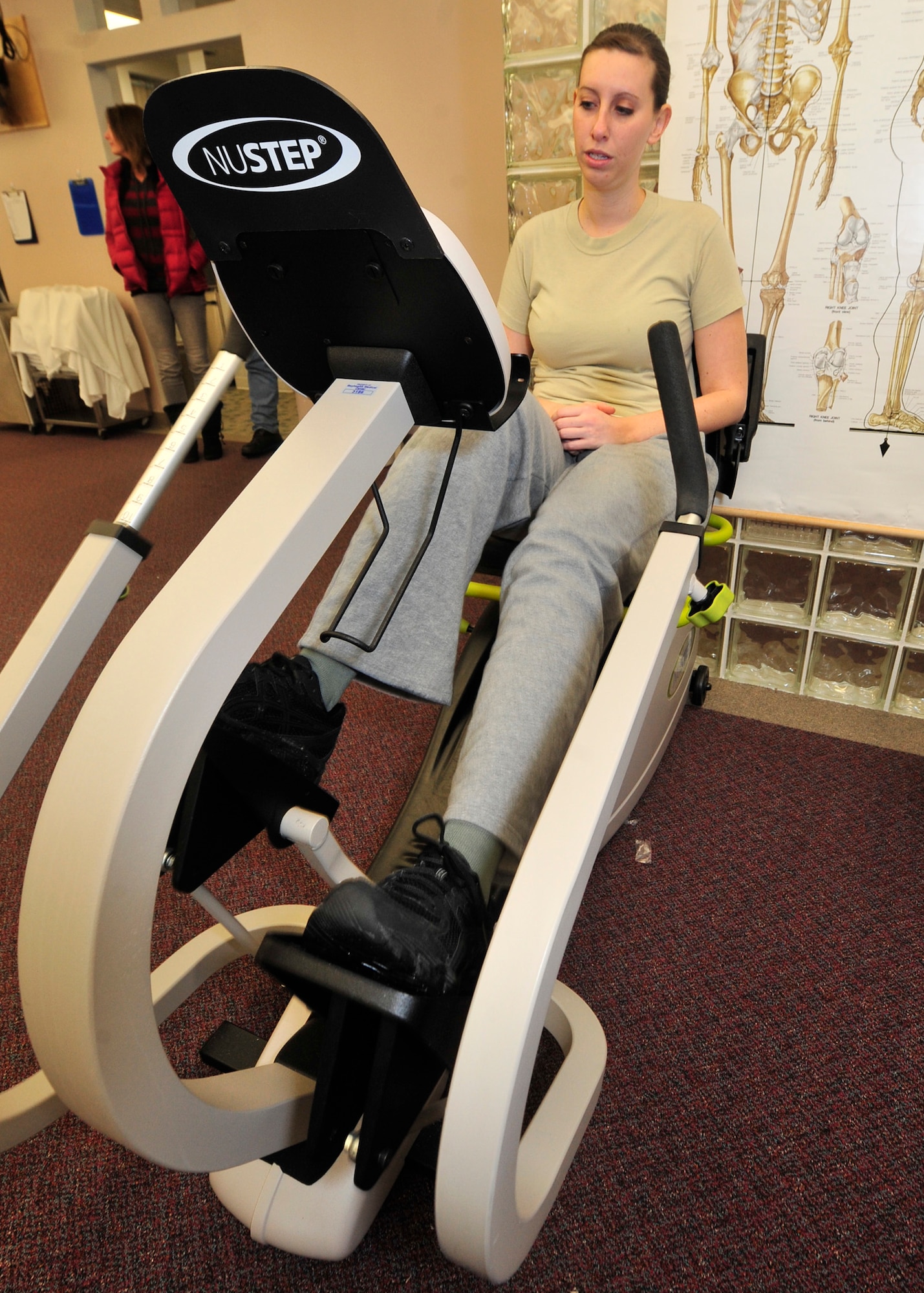 Airman 1st Class Lori Cord pedals a stationary bike Feb. 1, 2013, at the Bay Health Physical Therapy Center in Dover, Del. Biking is one of the activities that will help strengthen Cord’s leg from the affects of Guillain-Barre Syndrome. (U.S. Air Force photo by Tech. Sgt. Chuck Walker)