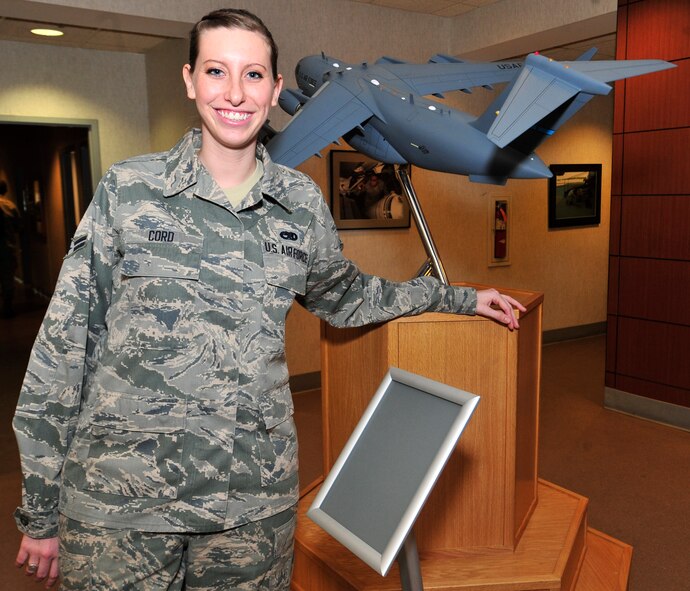 Airman 1st Class Lori Cord, 436th Aircraft Maintenance Squadron crew chief, stands in the lobby of the 436th AMXS Jan. 28, 2013, on Dover Air Force Base, Del. Cord is in the midst of recovering from Guillain-Barre Syndrome and was back to work for the first time since suffering from the illness. (U.S. Air Force photo by Tech. Sgt. Chuck Walker)