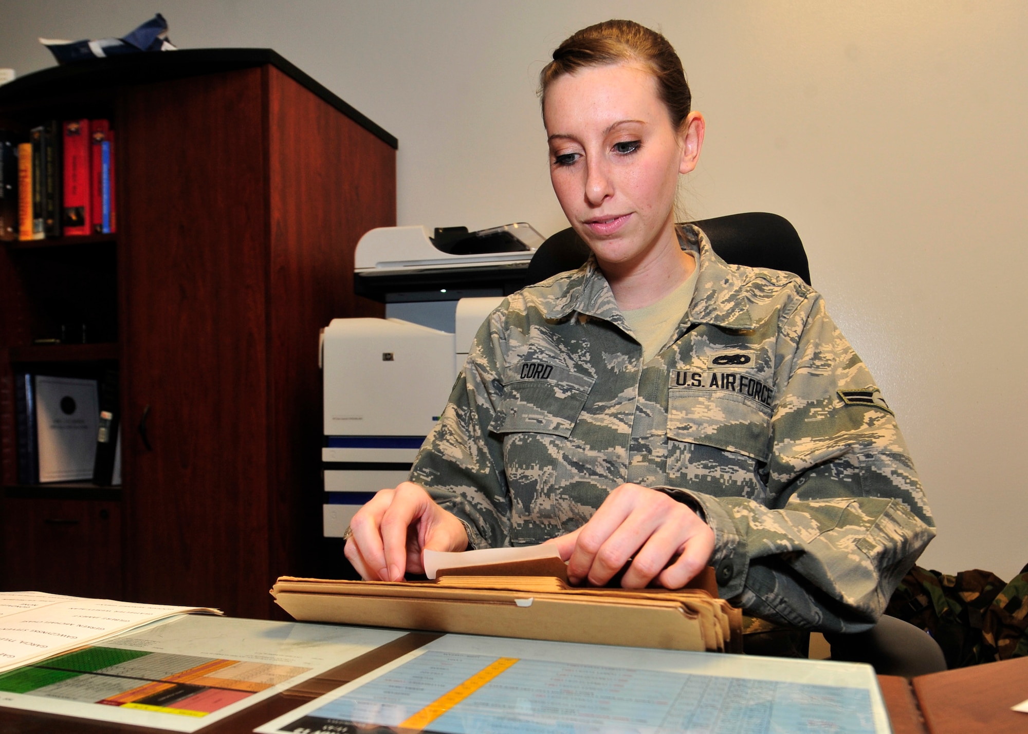 Airman 1st Class Lori Cord, 436th Aircraft Maintenance Squadron crew chief, places labels on folders Jan. 28, 2013, at the 436th AMXS on Dover Air Force Base, Del. Cord, who has been recovering from Guillain-Barre Syndrome since late Oct. 2012, was back for her first day of work since suffering from the illness. (U.S. Air Force photo by Tech. Sgt. Chuck Walker)
