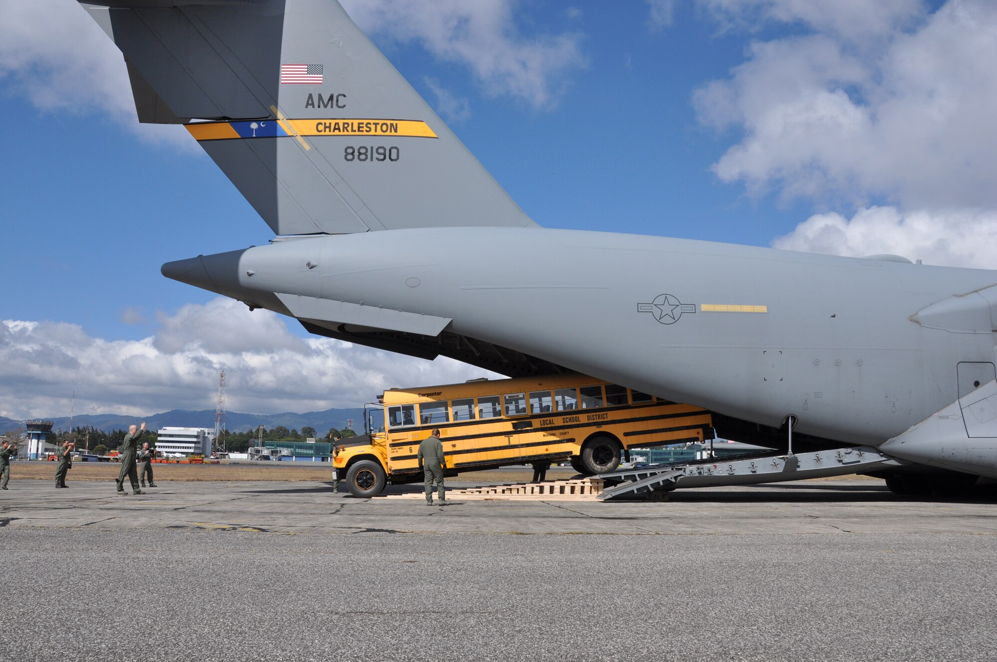Reservists from the 300th Airlift Squadron stationed at Joint Base Charleston, Air Base, S.C. offload a donated school bus in Guatemala Sunday, Feb. 3, 2012.  The bus will allow children to attend school who may otherwise not have the opportunity to obtain an education throughout the area.  (U.S. Air Force photo by Capt. Wayne Capps)