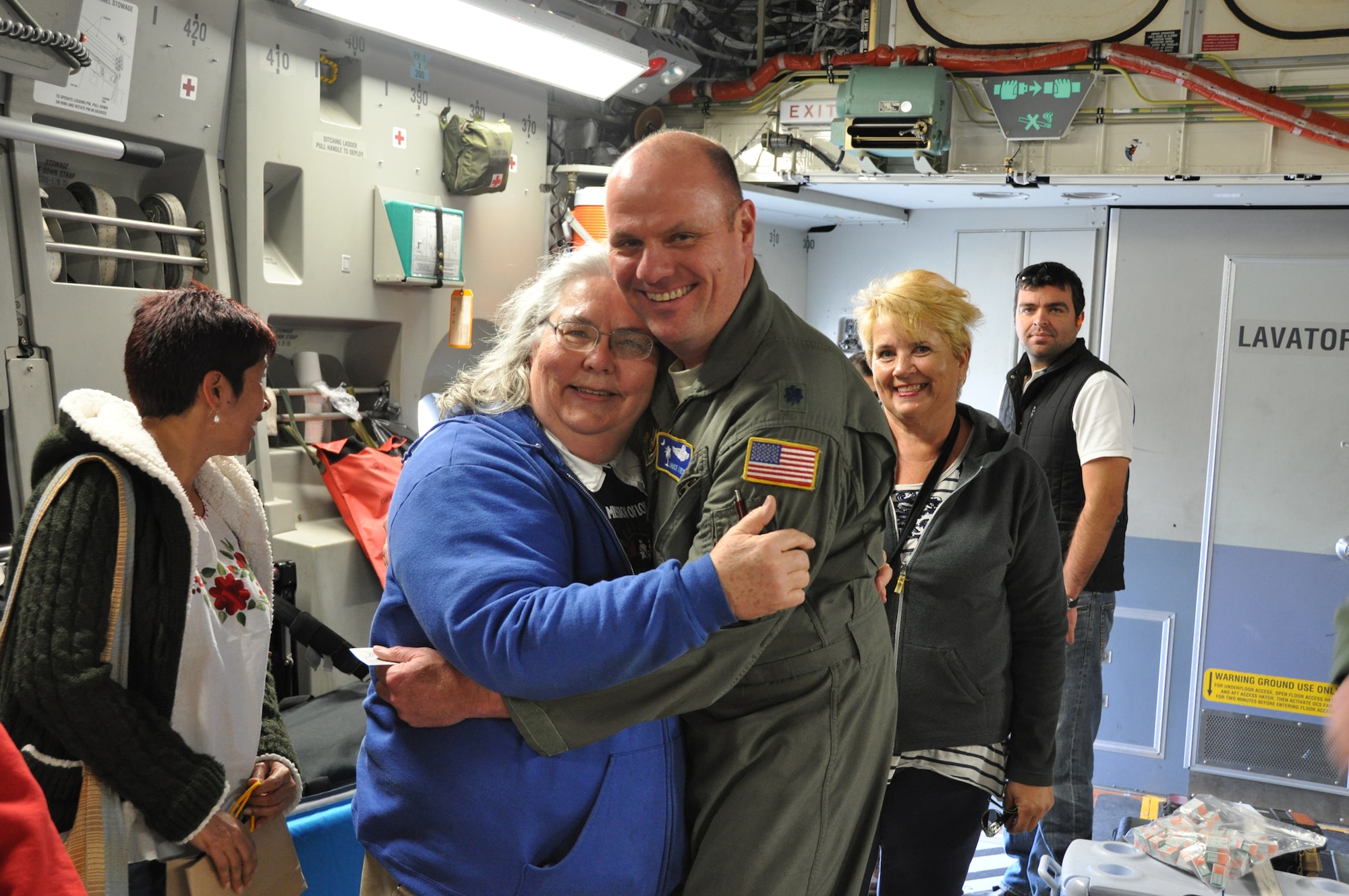 Lt. Colonel Lance K. Livesey, systems training officer with the 300th Airlift Squadron at Joint Base Charleston, Air Base, S.C. receives a hug from Kathleen Price, founder and director of Mission of Love Foundation, a non-profit organization based in Austintown, Ohio. Livesey, along with several other reservists assigned to the 300 AS, delivered a school bus, food and medical supplies to Guatemala Sunday, Feb. 3, 2012 in support of Price's humanitarian efforts there. (U.S. Air Force photo by Senior Airman Bobby Pilch)