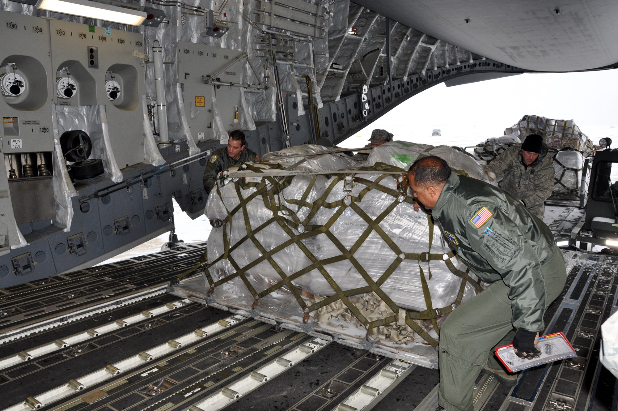 Reservists from the 300th Airlift Squadron stationed at Joint Base Charleston, Air Base, S.C. and Youngstown Air Reserve Station, Ohio load food and medical supplies here  for families and children in Guatemala Saturday, Feb. 2, 2013.  The aid will help more than 1,000 residents  throughout the area according to Kathleen Price, founder and director of Mission of Love Foundation, a non-profit organization based in Youngstown, Ohio. (U.S. Air Force photo by Senior Airman Bobby Pilch)