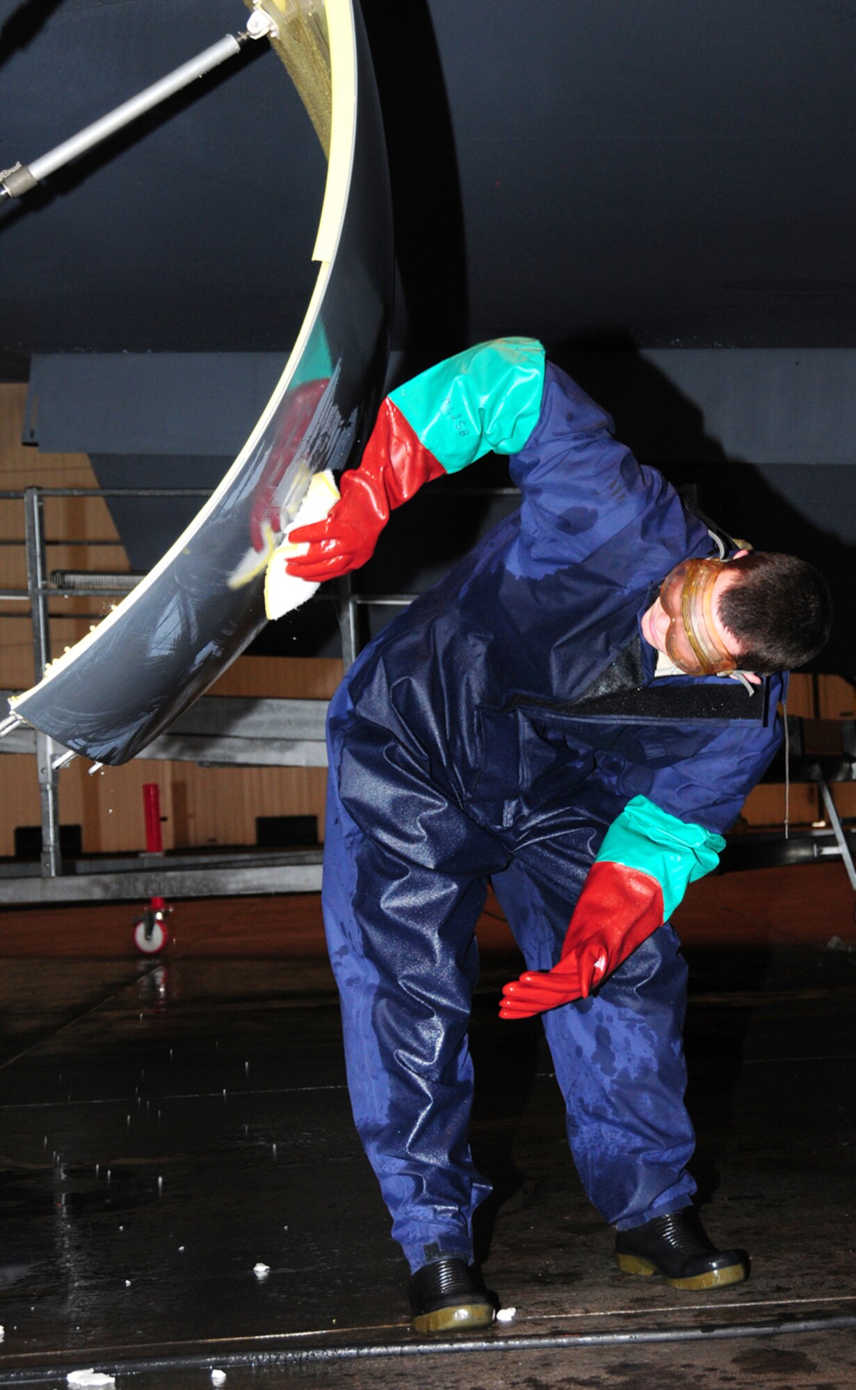Senior Airman Eric Wietstruk, 100th Aircraft Maintenance Squadron crew chief, washes a KC-135R Stratotanker Jan. 25, 2013, in hangar 711 at RAF Mildenhall, England. As a crew chief, he is responsible for safely generating, performing inspections on and servicing the multi-million dollar aircraft. The Warner Robbins, Ga., native also performs launch and recovery of aircraft, refueling, major maintenance such as removing or installing parts, and marshalling aircraft. (U.S. Air Force photo by Karen Abeyasekere/Released)