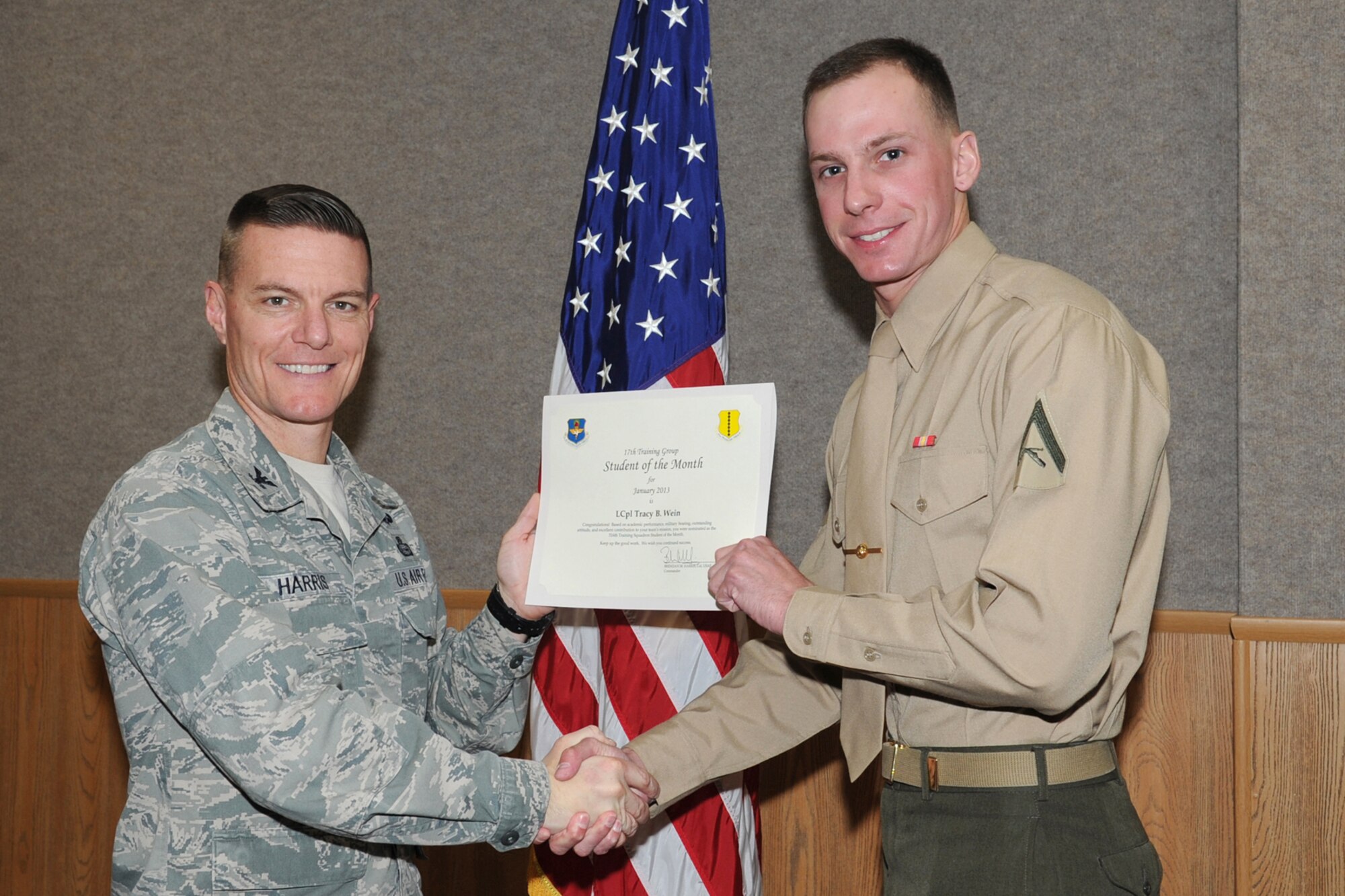 GOODFELLOW AIR FORCE BASE, Texas- Col. Brendan Harris, 17th Training Group Commander, presents U.S. Marine Corps Lance Cpl. Tracy Wein with the 316th Training Squadron Student of the Month award for January here, Feb. 1. (U.S. Air Force photo/ Staff Sgt. Laura R. McFarlane)