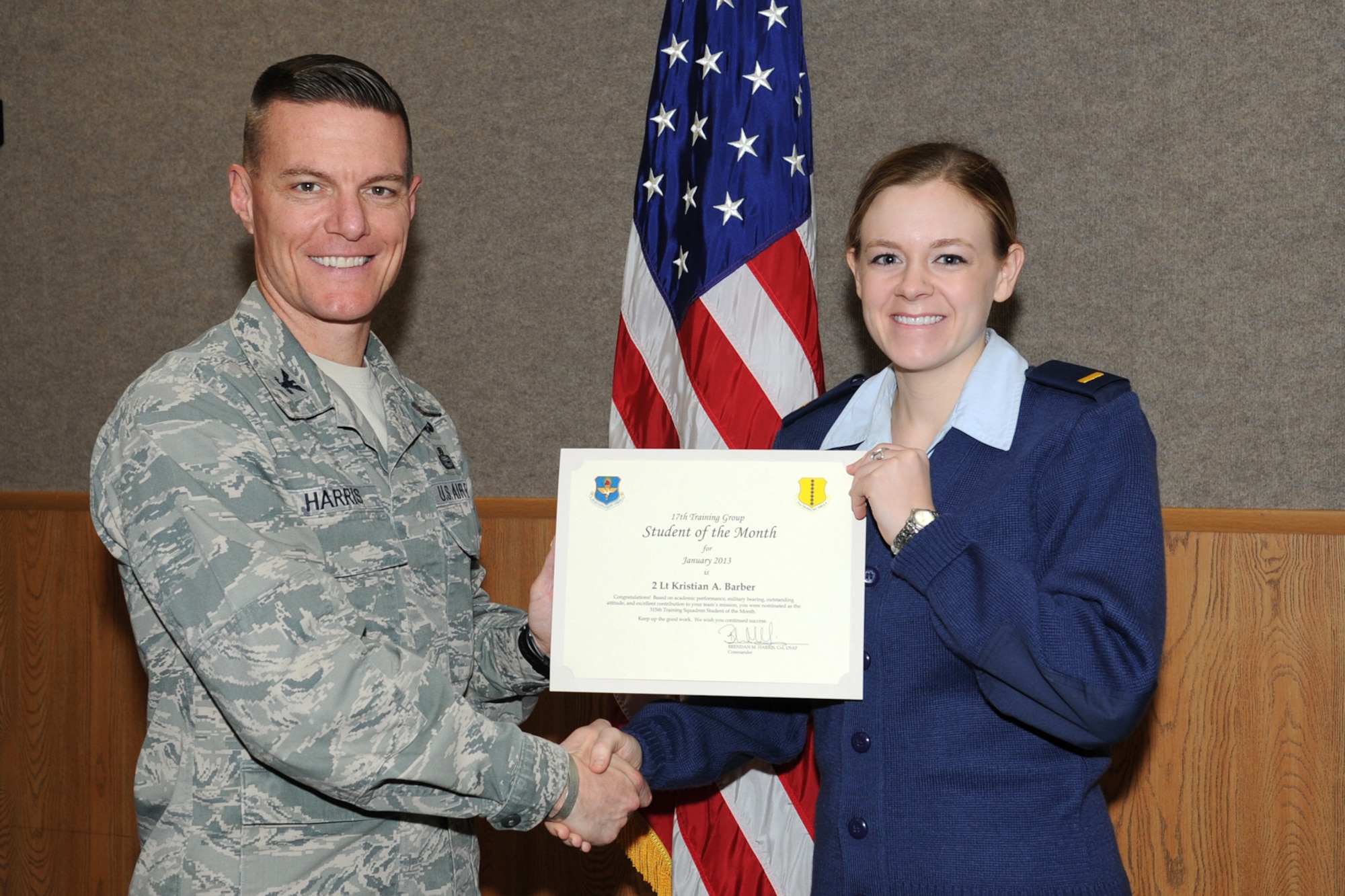 GOODFELLOW AIR FORCE BASE, Texas- Col. Brendan Harris, 17th Training Group Commander, presents 2nd Lt. Kristian Barber with the 315th Training Squadron Officer Student of the Month award for January here, Feb. 1. (U.S. Air Force photo/ Staff Sgt. Laura R. McFarlane)