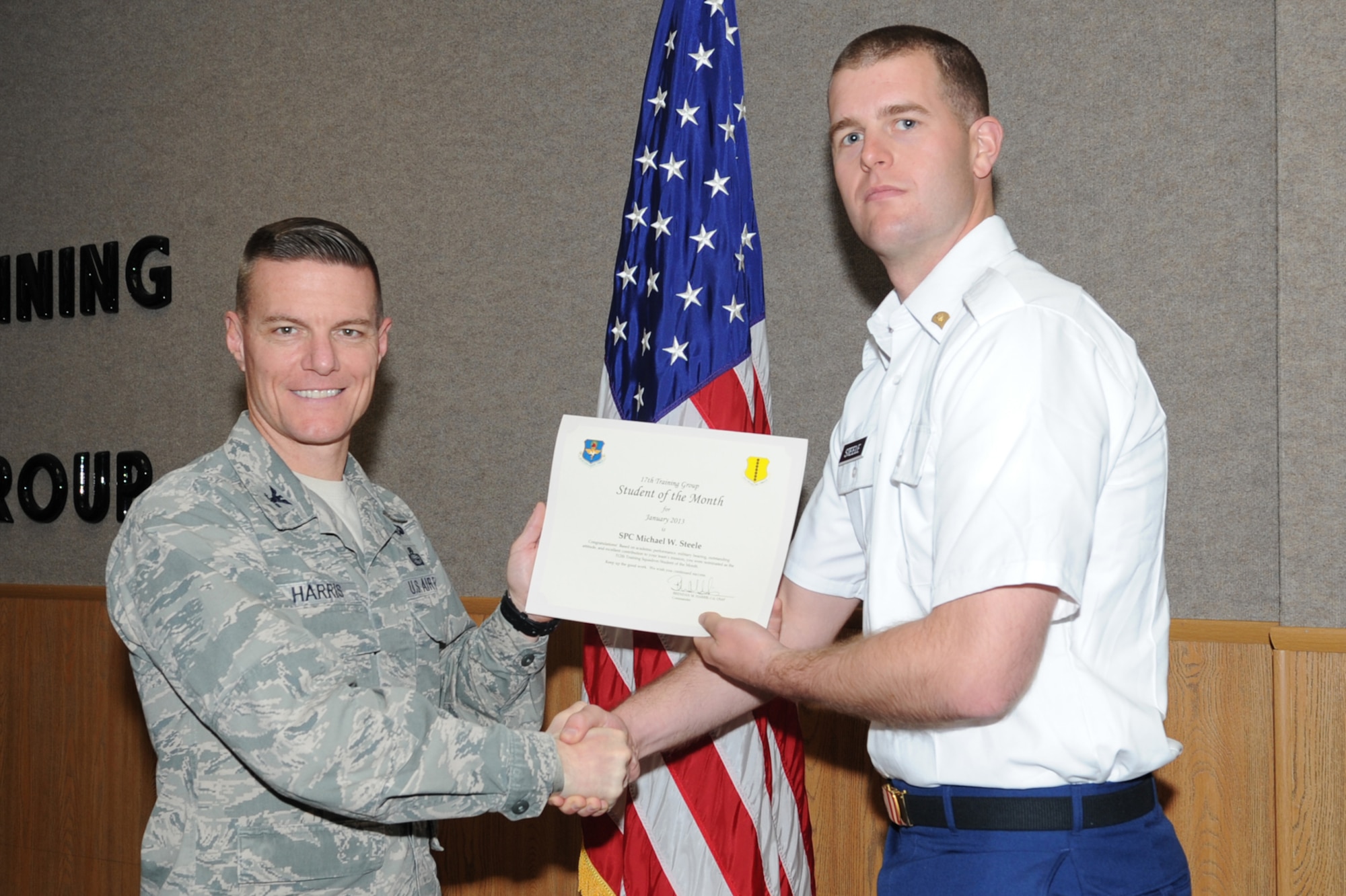 GOODFELLOW AIR FORCE BASE, Texas- Col. Brendan Harris, 17th Training Group Commander, presents U.S. Army Spc. Michael Steele with the 312th Training Squadron Student of the Month award for January here Feb. 1. (U.S. Air Force photo/ Staff Sgt. Laura R. McFarlane)