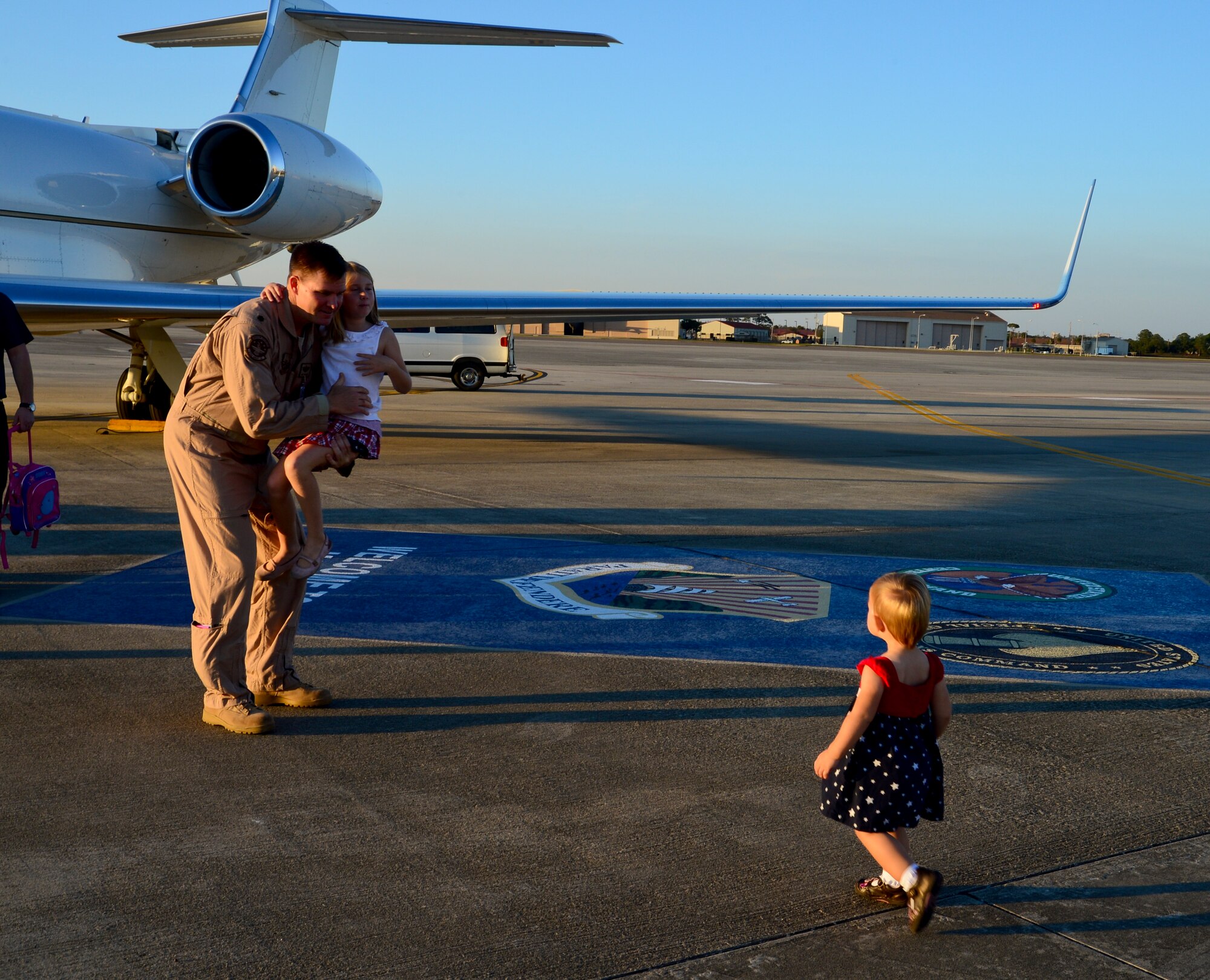 Lt. Col. Kurt Kremser, 310th Airlift Squadron C37A pilot, says farewell to his children, Elisa, 6, and Katherine, 19 months, at MacDill Air Force Base, Fla., Jan. 27, 2013 prior to leaving for an approximately three month deployment. This is the first time the 310th AS has ever deployed. (U.S. Air Force photo by Senior Airman Melissa Paradise/Released)