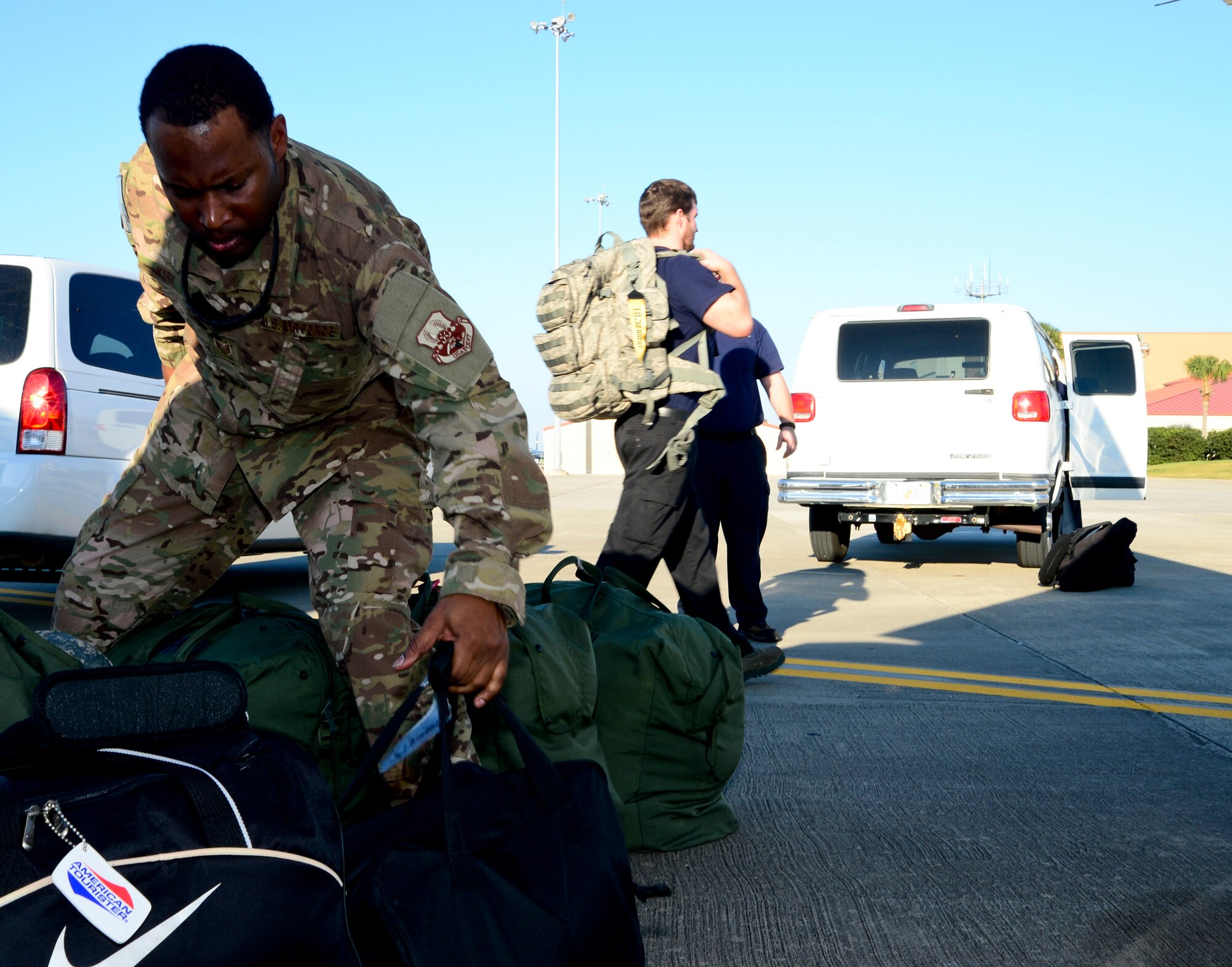 Technical Sgt. Kai Kirk, 310th Airlift Squadron aviation resource manager, unloads deployment bags from a van in preparation for a deployment at MacDill Air Force Base, Fla., Jan. 27, 2013. The 310th AS, which was established in 2001, sent approximately 15 members on its first ever deployment. (U.S. Air Force photo by Senior Airman Melissa Paradise/Released)