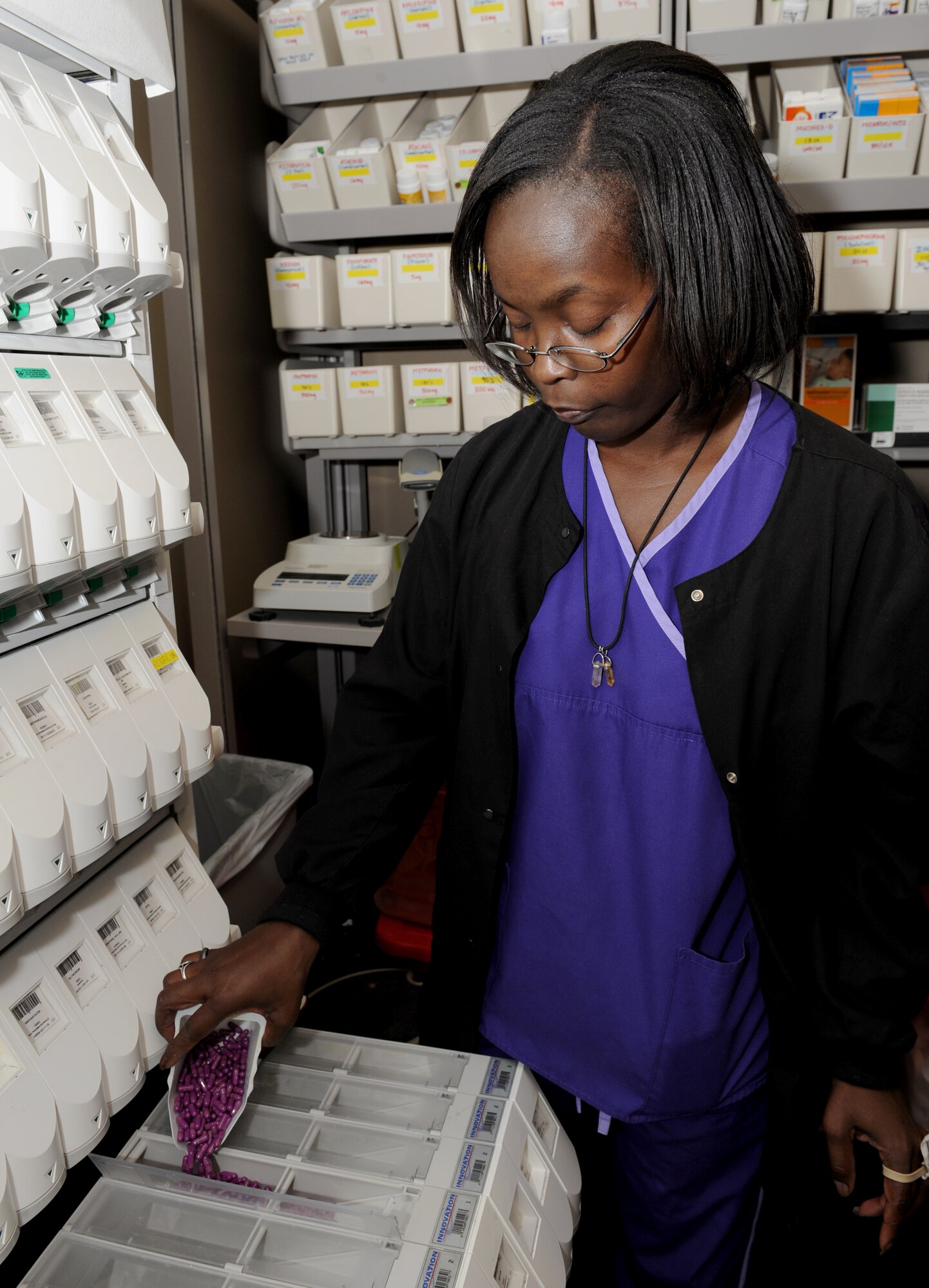 Terri Savage-Campbell, 2nd Medical Support Squadron pharmacy technician, refills a dispenser at the base pharmacy on Barksdale Air Force Base, La., Feb. 4. The medication dispenser contains more than 100 prescription drugs that are commonly prescribed. This machine allows fast and accurate distribution of medication. (U.S. Air Force photo/Airman 1st Class Benjamin Gonsier)
