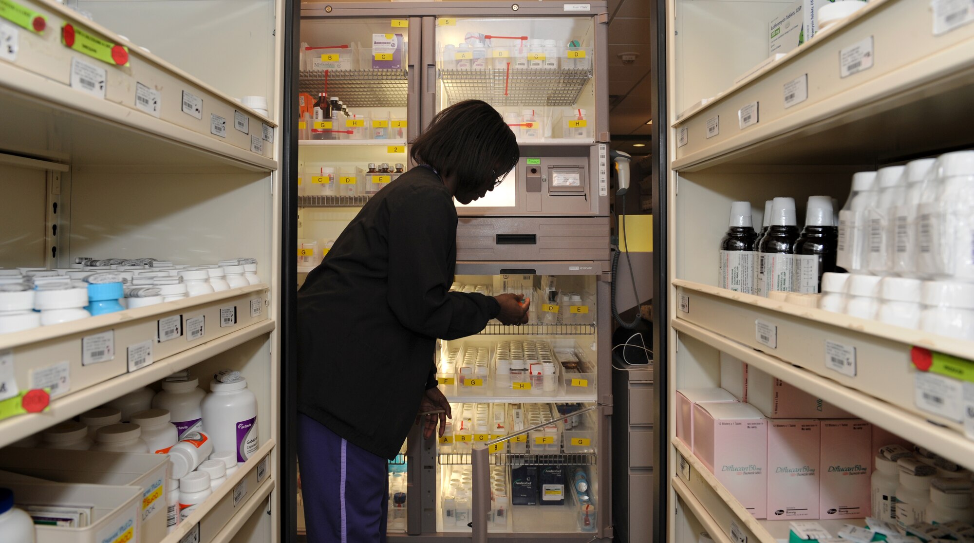 Terri Savage-Campbell, 2nd Medical Support Squadron pharmacy technician, looks for medication at the base pharmacy on Barksdale Air Force Base, La., Feb. 4. Some medication is stored inside a secured storage area called Pyxis CII safe, which ensures only authorized individuals have access to the medication inside. (U.S. Air Force photo/Airman 1st Class Benjamin Gonsier)
