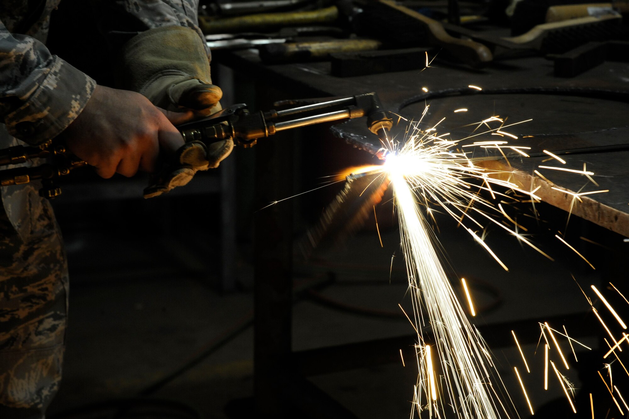 Airman 1st Class Jacob Stevens, 2nd Civil Engineer Squadron structures section, cuts through a sheet of metal with an oxyacetylene torch on Barksdale Air Force Base, La., Feb. 4. Stevens is currently training with different tools and equipment to earn his journeyman skill level. Training consists of approximately 15 months of on-the-job training before Airmen upgrade to journeyman. (U.S. Air Force photo/Airman 1st Class Andrew Moua)