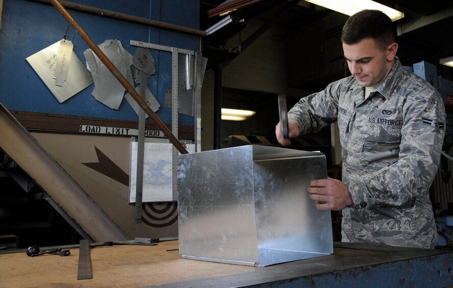 Airman 1st Class Jacob Stevens, 2nd Civil Engineer Squadron structures section, hammers metal into the shape of an air duct on Barksdale Air Force Base, La., Feb. 4. The structures shop's responsibilities include roof repairs, replacing doors and glass, metal working, masonry and carpentry. (U.S. Air Force photo/Airman 1st Class Andrew Moua)