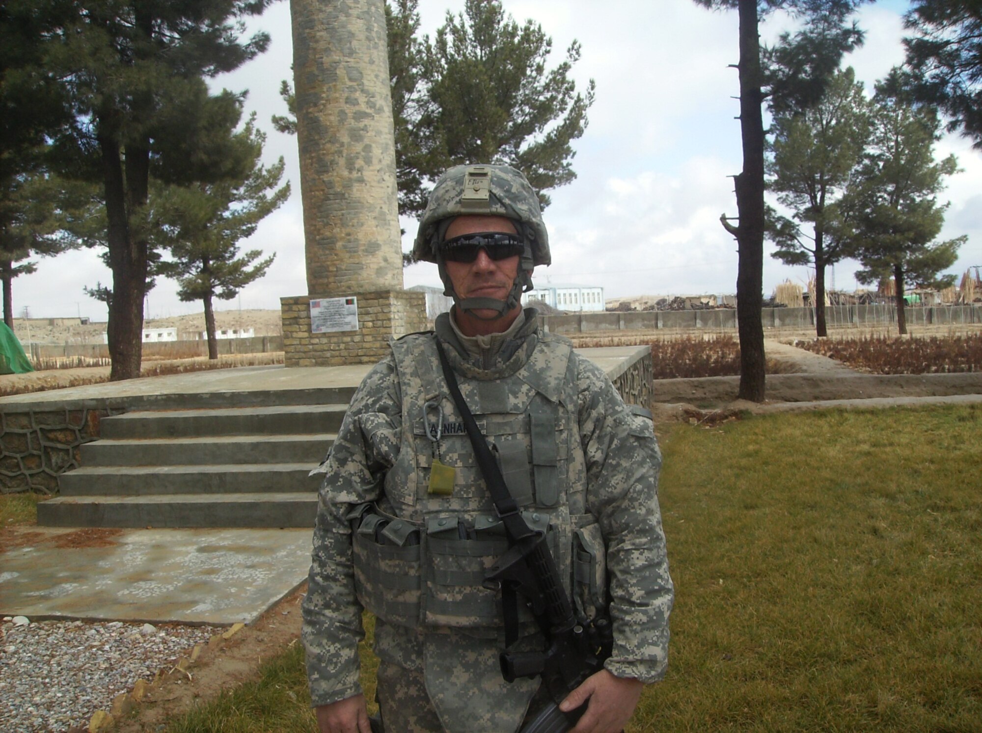 Tech. Sgt. Will Earnhart stands in front of a graden in the Zabul Provice of Afghanistan in 2011. He, along with Master Sgt. John Weston helped natives get agricultural projects started so that they could survive and make money.