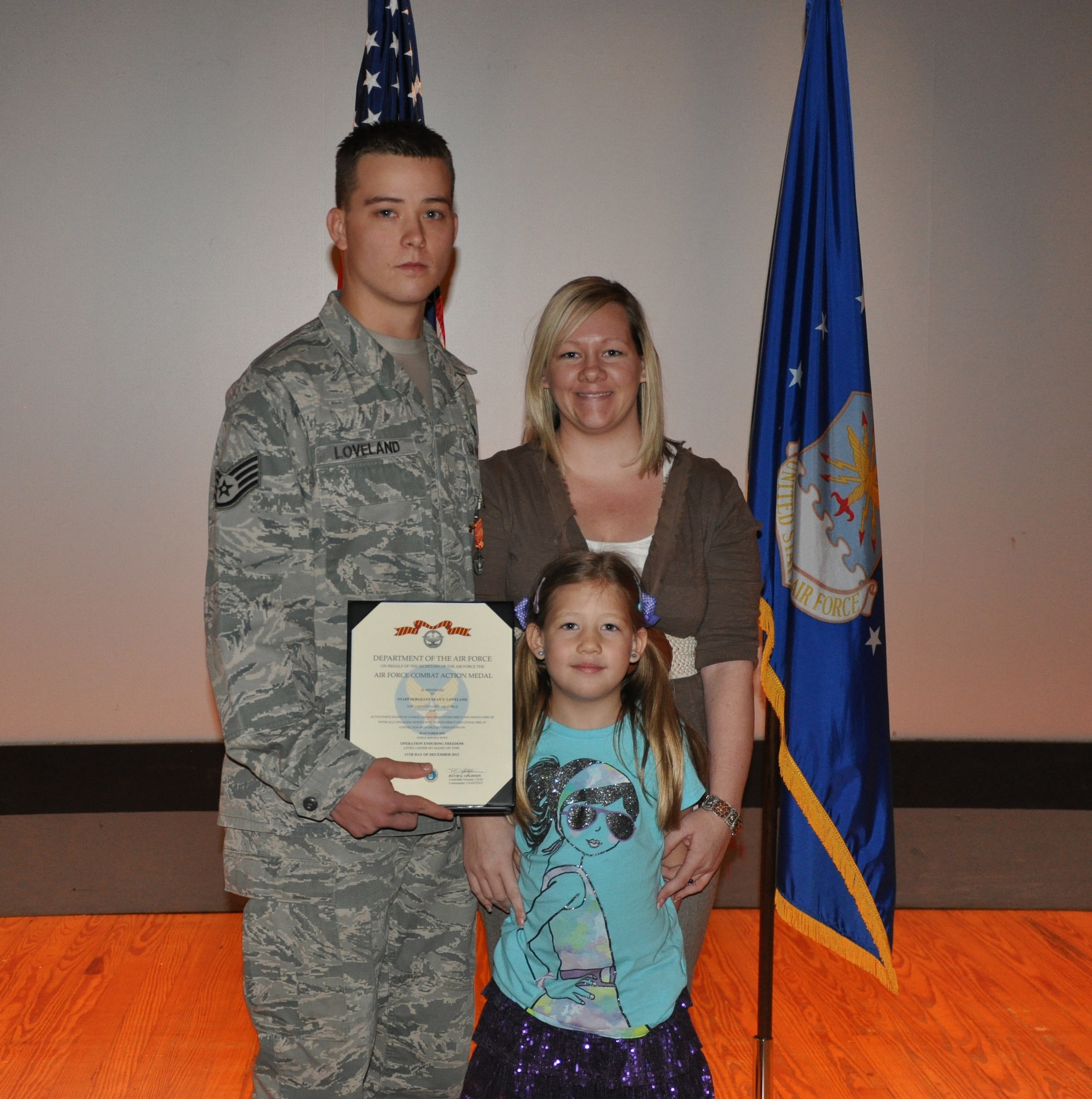 GOODFELLOW AIR FORCE BASE, Texas- Staff Sgt. Sean Loveland, 316th Training Squadron instructor, poses with his family after receiving the Air Force Combat Action Medal at the Base Theater here, Jan. 25. On Oct. 20, 2010, Loveland actively engaged enemy forces while conducting a mission with the Army 3rd Platoon, Headquarters and Headquarters Company 101st Airborne Division near the Nawa Valley in Afghanistan. (U.S. Air Force photo/ Airman 1st Class Erica Rodriguez)