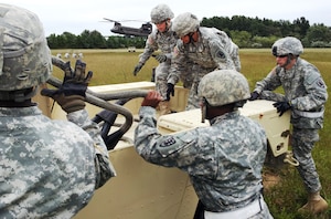 U.S. Army Soldiers assigned to the 53rd Movement Control Battalion, 7th Sustainment
Brigade, prepare to sling-load a humvee to a Chinook helicopter during
slingload training at Felker Army Airfield, Fort Eustis, Va. (U.S. Army photo by Sgt. 1st Class Brian G. Rhodes/Released)
