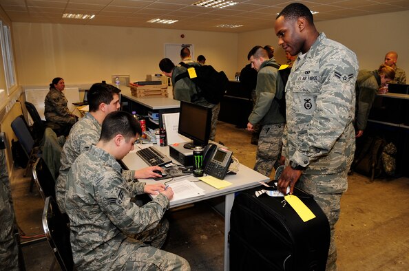 Airmen from the 100th Air Refueling Wing process through a pre-deployment line Jan. 14, 2013, at RAF Mildenhall, England. The 100th ARW will provide a much-needed air-to-air refueling capability to forces operating in Northern Africa. (U.S. Air Force photo by Airman 1st Class Dillon Johnston/Released)