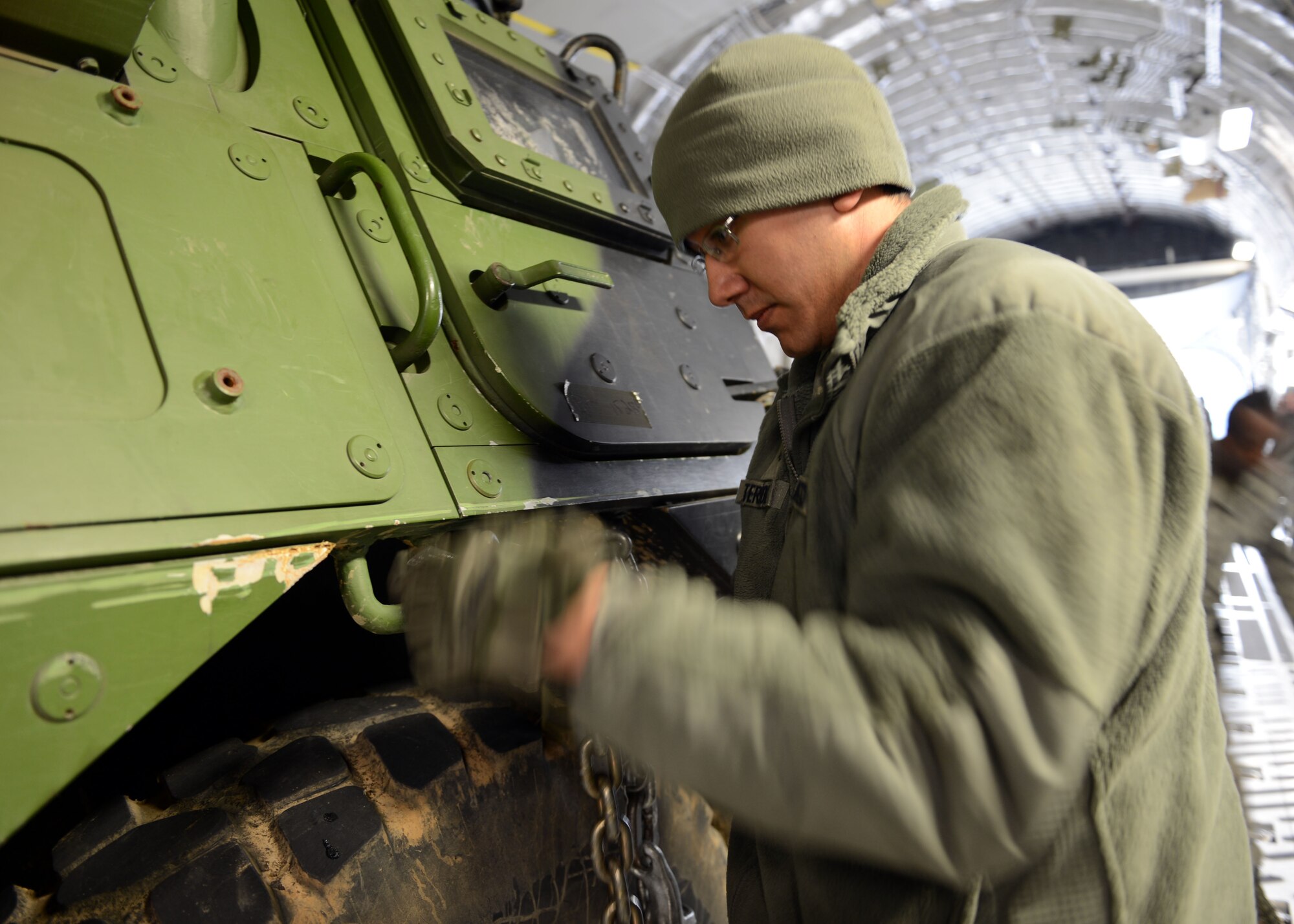 Airman 1st Class James Terronez, an aerial porter from Wichita, Kan., secures a French armored vehicle on a U.S. Air Force C-17 Globemaster in preparation for delivery to Bamako, Mali from Istres Air Base, France Feb. 4. Terronez, who is on his first deployment, is assigned to the 818th Contingency Response Group at Joint Base McGuire-Dix-Lakehurst, N.J. The U.S. military airlift efforts are in support of France's operations in Mali. (U.S. Air Force photo by Senior Master Sgt. Sarah R. Webb/RELEASED)