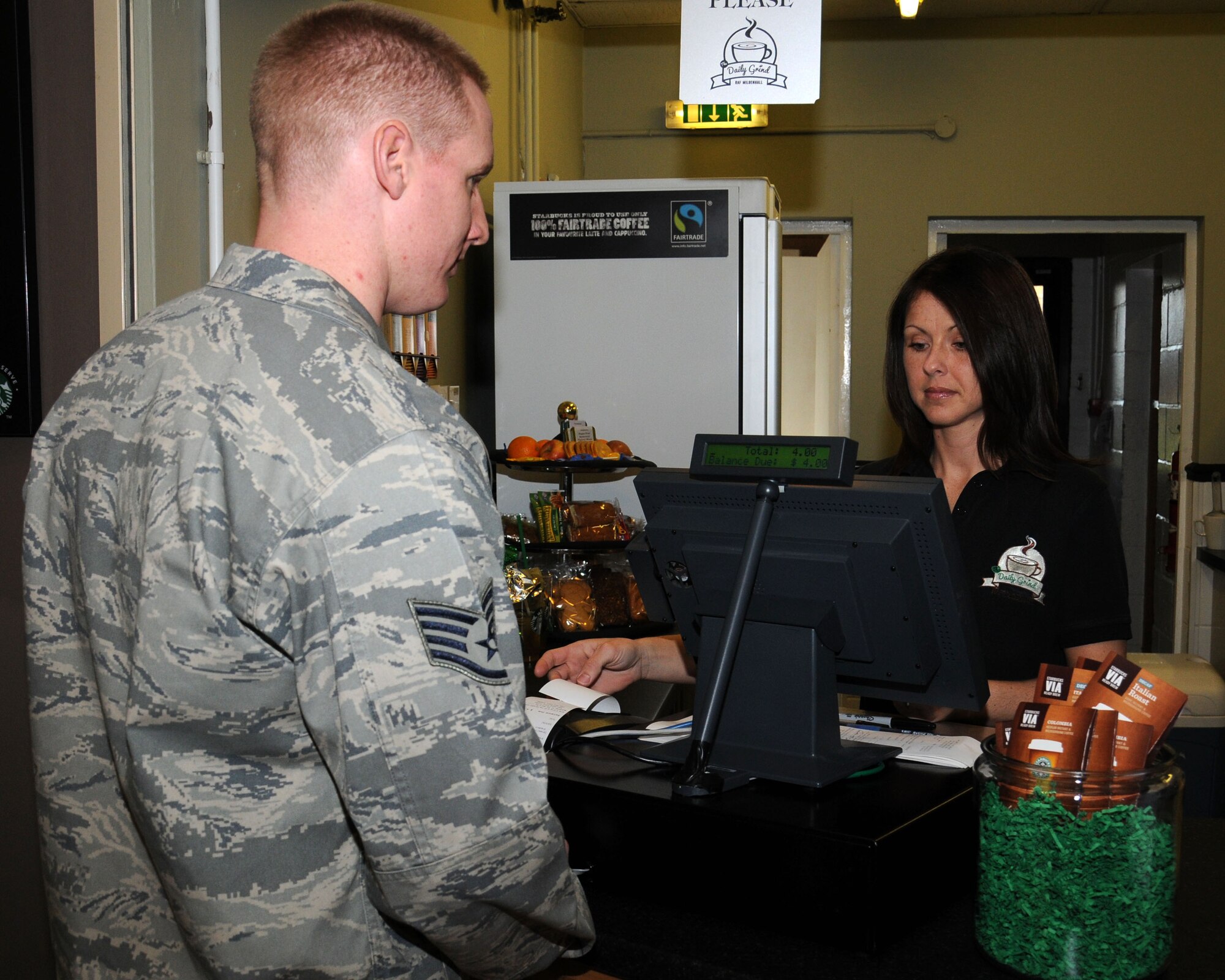 Dawn Updegrave, 100th Force Support Squadron Daily Grind supervisor serves a customer Feb. 4, 2013, in the Bob Hope Community Center at RAF Mildenhall, England. The daily grind was closed for refurbishment and re-opened Feb. 4, 2013. (U.S. Air Force photo by Gina Randall/Released)