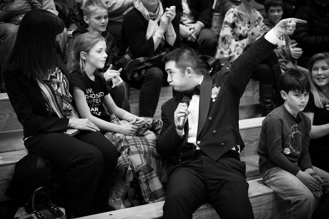 YOKOTA AIR BASE, Japan -- Tech. Sgt. Justin Allen, Band of the Pacific-Asia vocalist, interacts within the audience at the Yokota Middle School, Yokota Air Base, Japan, Jan. 30, 2013. "Getting up close and interacting bridges the gap between the band and the audience and allows us to make a more personal connection," stated Allen. (U.S. Air Force photo by Staff Sgt. Josh Voyles)