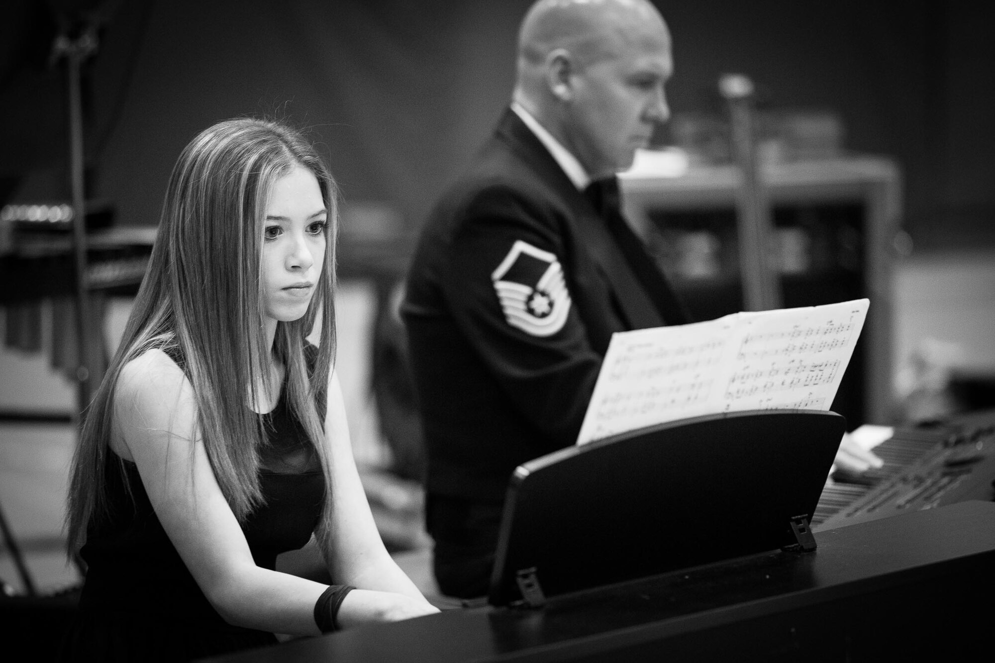 YOKOTA AIR BASE, Japan -- Yokota Middle School student Anna Dublino plays alongside her father Master Sgt. Vincent Dublino, Band of the Pacific-Asia pianist, at the Yokota Middle School, Yokota Air Base, Japan, Jan. 30 2013. The concert showcased student talent and supported Airmen and their families. (U.S. Air Force photo by Staff Sgt. Josh Voyles)