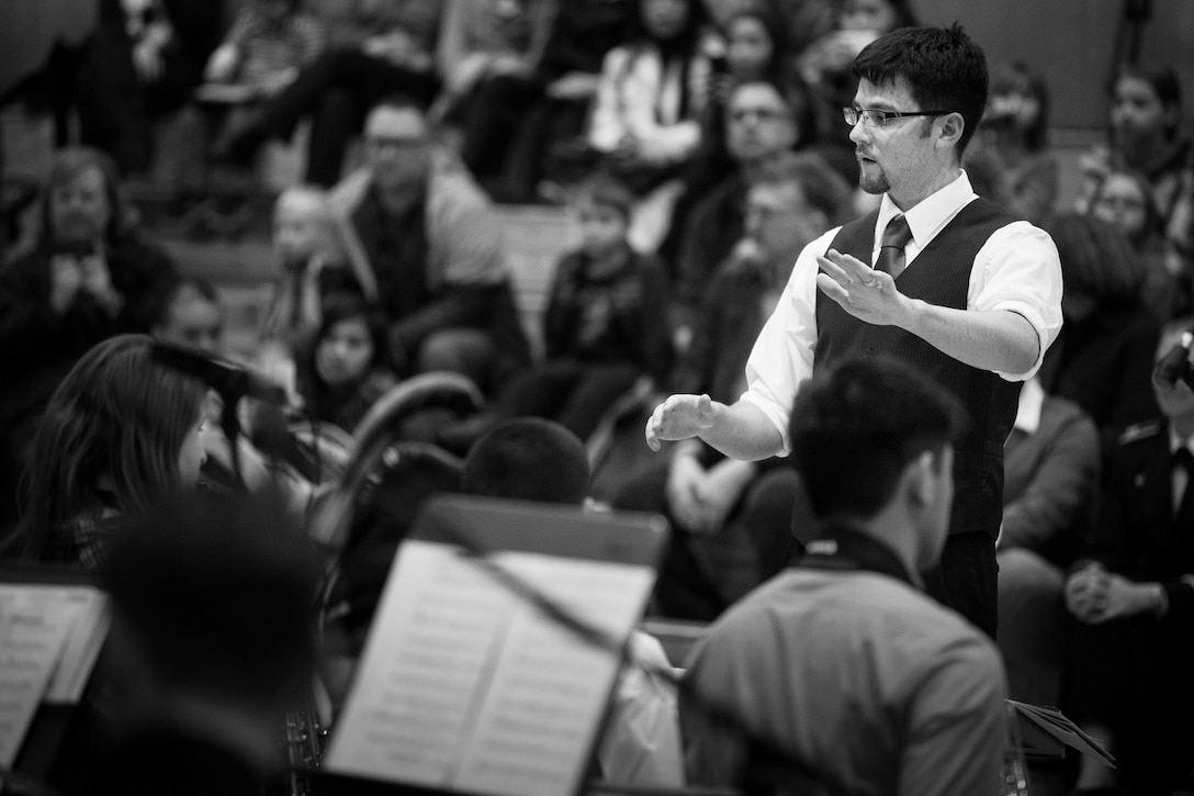 YOKOTA AIR BASE, Japan -- Mr. David Doescher, Yokota Middle School volunteer jazz band director, conducts the students during the joint concert with Pacific Showcase, Band of the Pacific-Asia jazz ensemble, at the Yokota Middle School, Yokota Air Base, Japan, Jan. 30, 2013. (U.S. Air Force photo by Staff Sgt. Josh Voyles)