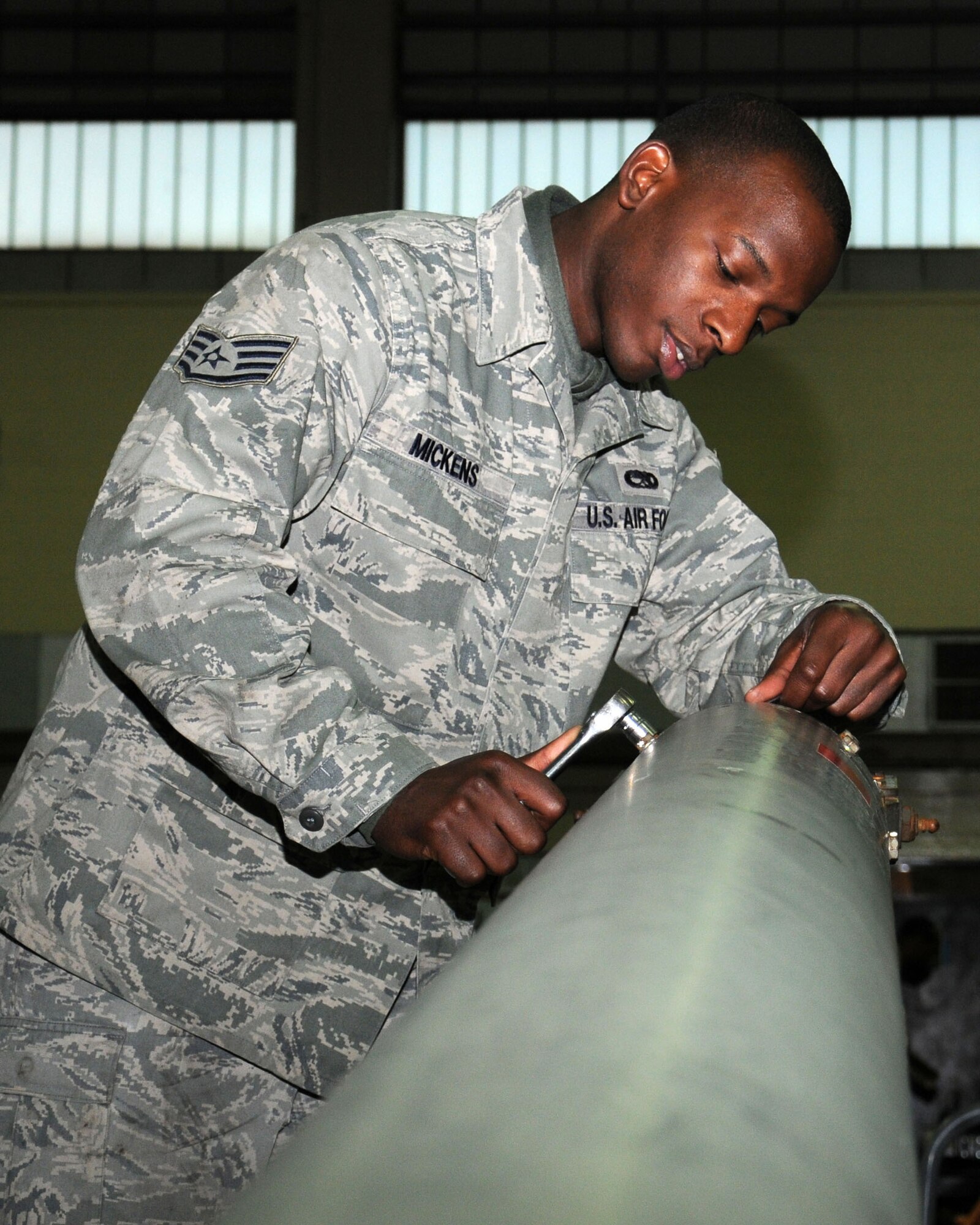 Staff Sgt. Reginald Mickens, 100th Maintenance Squadron Aerospace Ground Equipment journeyman from Sumter, S.C., tightens the bolts on a tow-bar of a KC-135R stratotanker to ensure it is ready for mission requirements Jan. 30, 2013, at RAF Mildenhall, England. The section supplies aircraft equipment to all of the flying units on the base. (U.S. Air Force photo by Gina Randall/Released)