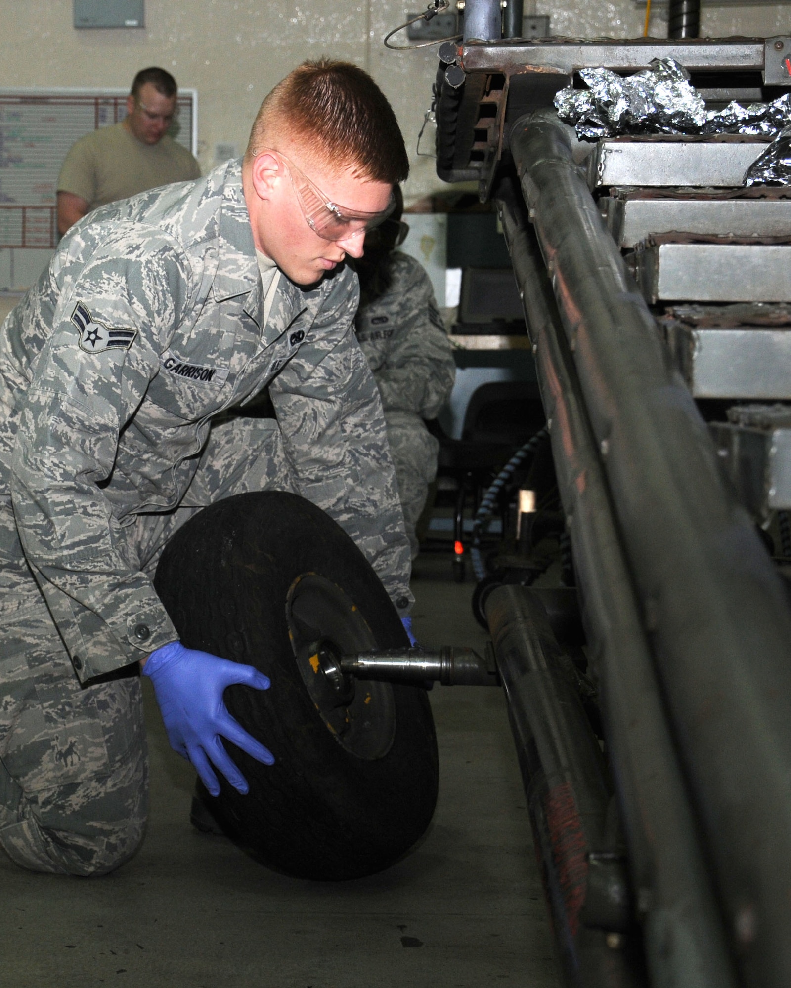 Airman 1st Class Christopher Garrison, 100th Maintenance Squadron Aerospace Ground Equipment apprentice from McKinney, Texas, changes the wheel-bearings on an aircraft maintenance stand Jan. 30, 2013, at RAF Mildenhall, England. This piece of equipment is used to allow personnel access to the wing of the plane for maintenance of the aircraft. (U.S. Air Force photo by Gina Randall/Released)