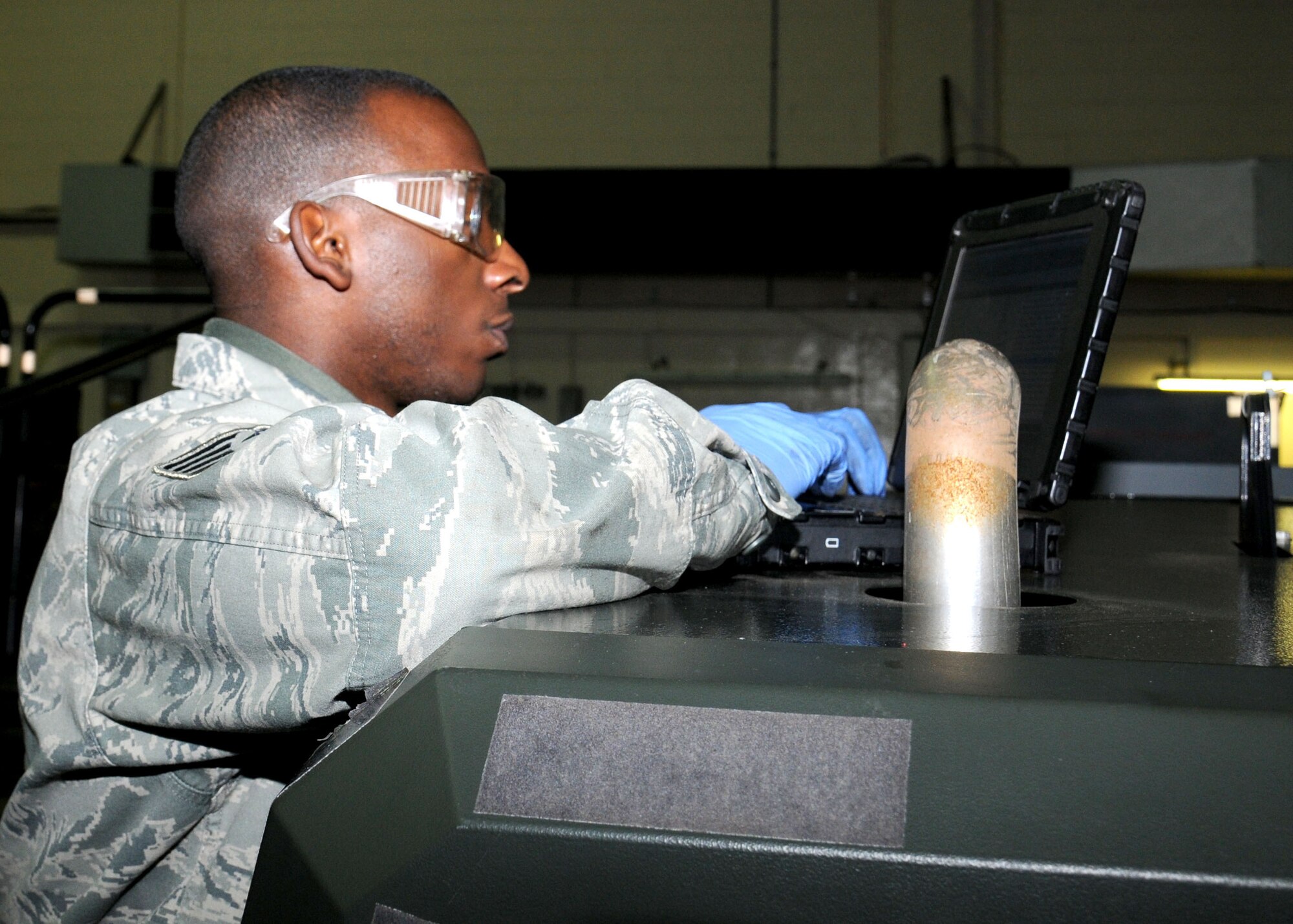 Staff Sgt. Reginald Mickens, 100th Maintenance Squadron Aerospace Ground Equipment journeyman from Sumter, S.C., checks an electronic technical order prior to performing an oil change Jan. 30, 2013, at RAF Mildenhall, England. Mickens is a member of the 100th MXS AGE flight. (U.S. Air Force photo by Gina Randall/Released)