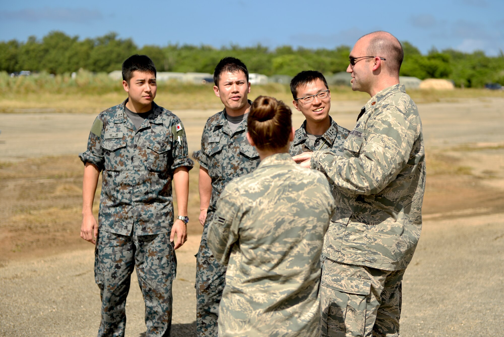 U.S. Air Force Maj. Paul Welter, Cope North 13 staff, white force intelligence, discusses humanitarian relief effort training with members of the Japan Air Self Defense Force on Northwest Field, Guam, Feb. 5, 2013. Cope North is a multilateral Pacific Air Forces-sponsored Field Training Exercise (FTX) conducted annually at Andersen Air Force Base, Guam. The exercise focuses on humanitarian assistance and disaster relief training, air combat tactics and large force employment in an effort to enhance interoperability among U.S., Japan and Australian forces. (U.S. Air Force photo by Senior Airman Matthew Bruch/RELEASED)