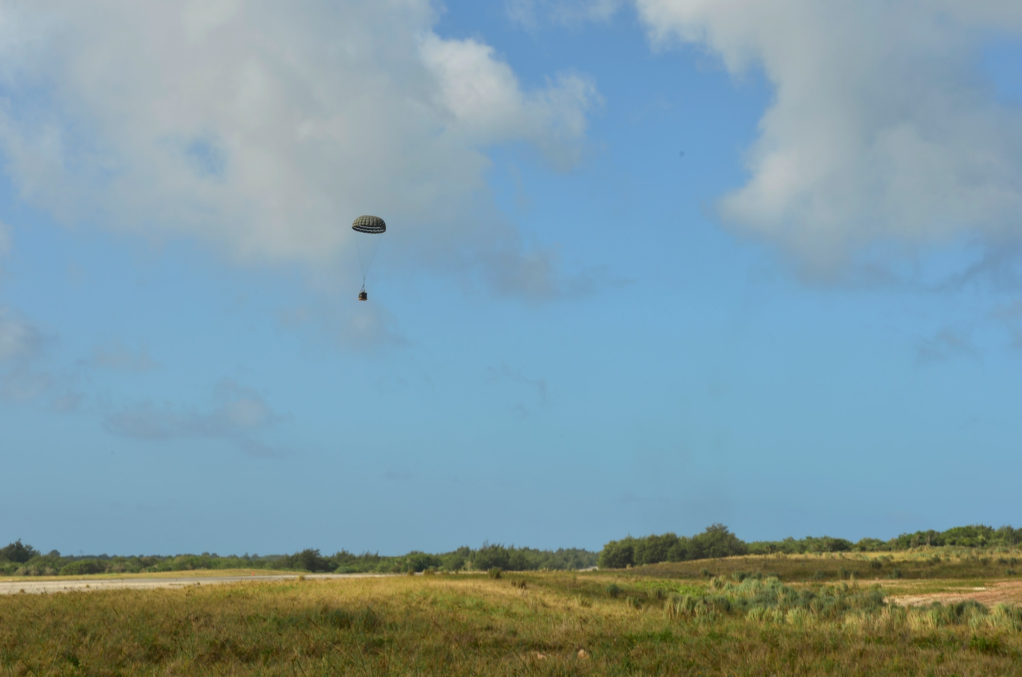 A C-130H drops a pallet over Northwest Field, Guam in support of Cope North 13, Feb. 5, 2013. Cope North 13 is a multilateral Pacific Air Forces-sponsored Field Training Exercise (FTX) conducted annually at Andersen Air Force Base, Guam. The exercise focuses on humanitarian assistance and disaster relief training, air combat tactics and large force employment in an effort to enhance interoperability among U.S., Japan and Australian forces. (U.S. Air Force photo by Senior Airman Matthew Bruch/RELEASED)