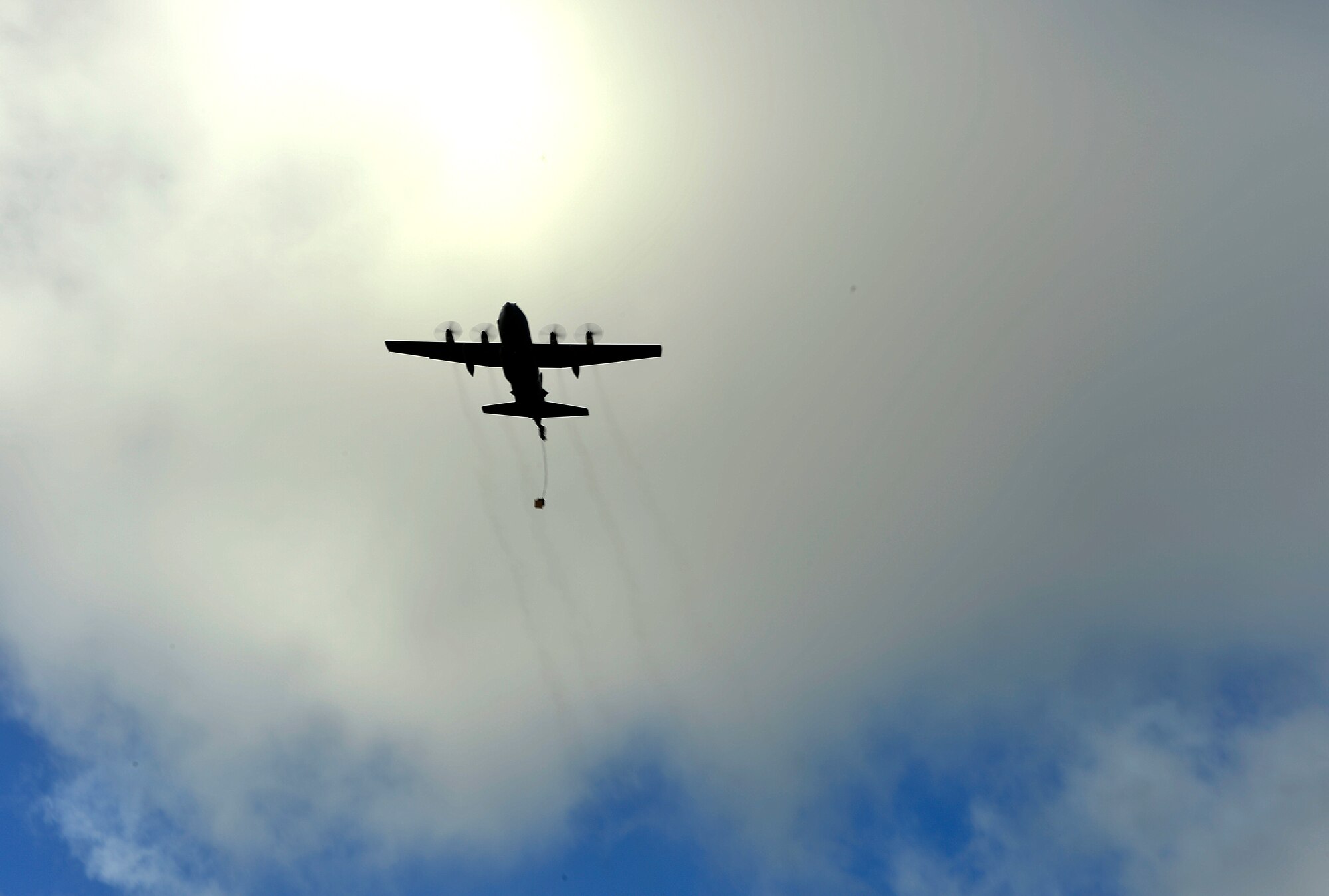 A U.S. Air Force C-130H flies over Northwest Field, Guam to perform an air drop while participating in Cope North 13, Feb. 5, 2013. Cope North is a multilateral Pacific Air Forces-sponsored Field Training Exercise (FTX) conducted annually at Andersen Air Force Base, Guam. The exercise focuses on humanitarian assistance and disaster relief training, air combat tactics and large force employment in an effort to enhance interoperability among U.S., Japan and Australian forces. (U.S. Air Force photo by Senior Airman Matthew Bruch/RELEASED)