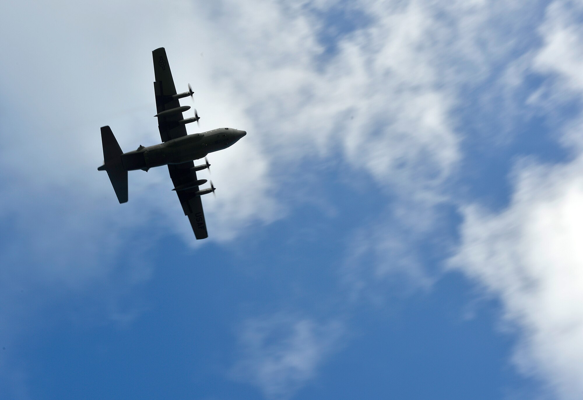 A U.S. Air Force C-130H flies over Northwest Field, Guam to perform an air drop while participating in Cope North 13, Feb. 5, 2013. Cope North is a multilateral Pacific Air Forces-sponsored Field Training Exercise (FTX) conducted annually at Andersen Air Force Base, Guam. The exercise focuses on humanitarian assistance and disaster relief training, air combat tactics and large force employment in an effort to enhance interoperability among U.S., Japan and Australian forces. (U.S. Air Force photo by Senior Airman Matthew Bruch/RELEASED)