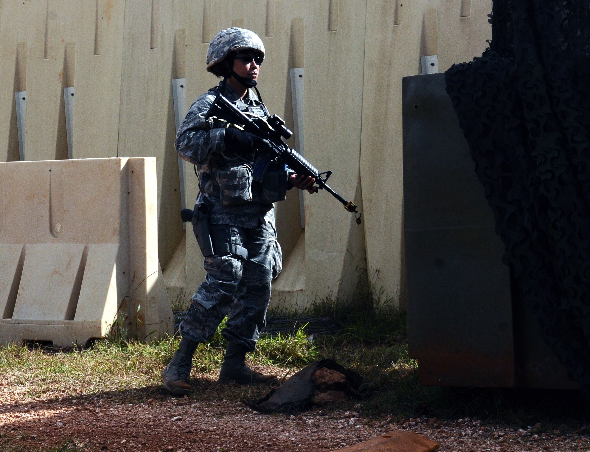 Senior Airman Jocelyn Morales-Onza, 154th Security Forces Squadron fire team member, stands guard at a simulated security check point at the Pacific Regional Training Center at Northwest Field, Guam, Jan. 27, 2013. The training center is designed to enhance basic skills and teach advanced tactics that Airmen need to deter threats downrange. (U.S. Air Force photo by Airman 1st Class Mariah Haddenham/Released)