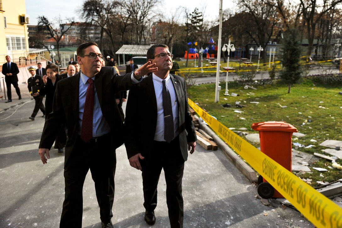 U.S. Deputy Defense Secretary Ashton B. Carter, right, and Jess Baily, left, deputy chief of mission at the U.S. Embassy in Ankara, Turkey, survey damage, Feb. 4, 2013, from a suicide bomber attack at the embassy.
