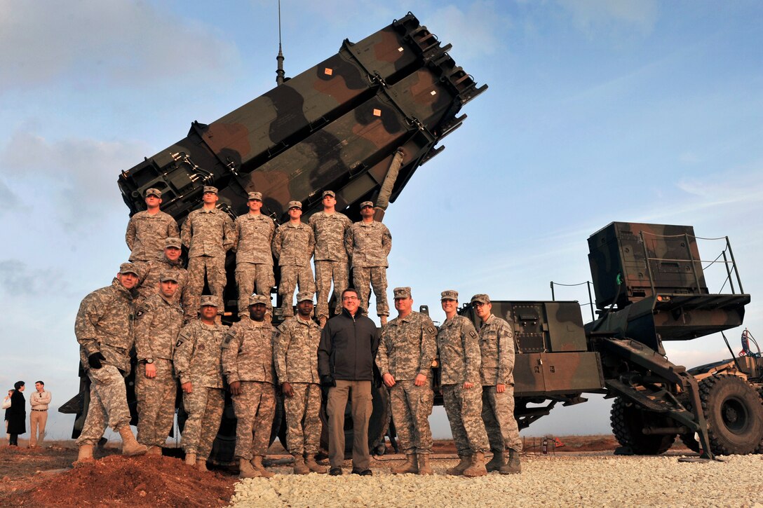 U.S. Deputy Defense Secretary Ashton B. Carter poses for a group photo with U.S. soldiers as he visits a Turkish army base in Gaziantep, Turkey, Feb. 4, 2013.