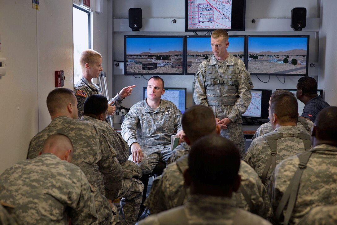 Army Capt. Robyn Boehringer, left, leads an after-action review after members of her company completed a mission on a virtual convoy trainer on Fort Bragg, N.C., Jan. 30, 2013. Boehringer, a company commander, is assigned to the 82nd Airborne Division’s 1st Brigade Combat Team. 